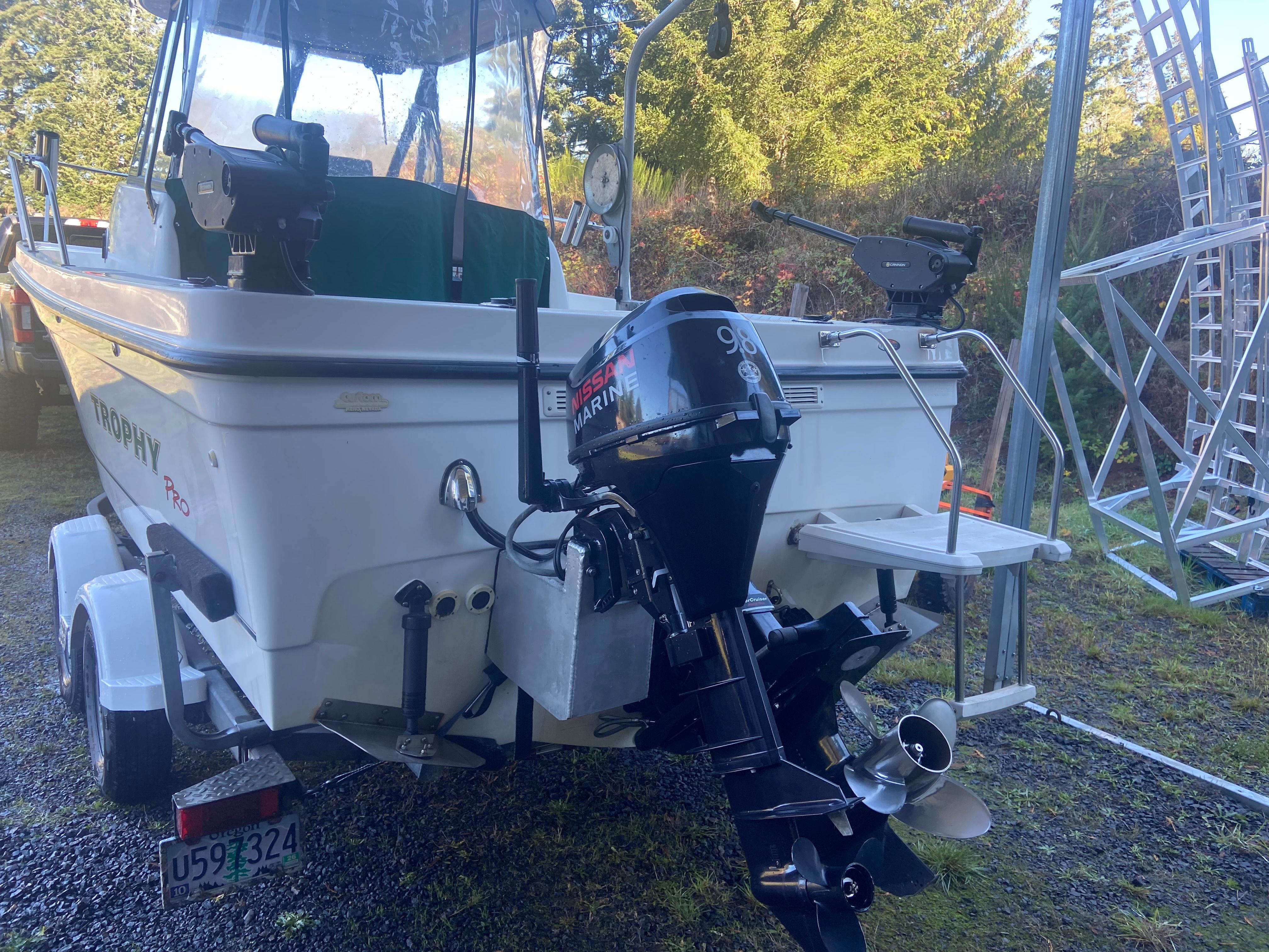 Rear view of a Bayliner Trophy Pro 2052 WA with outboard motor on a trailer.