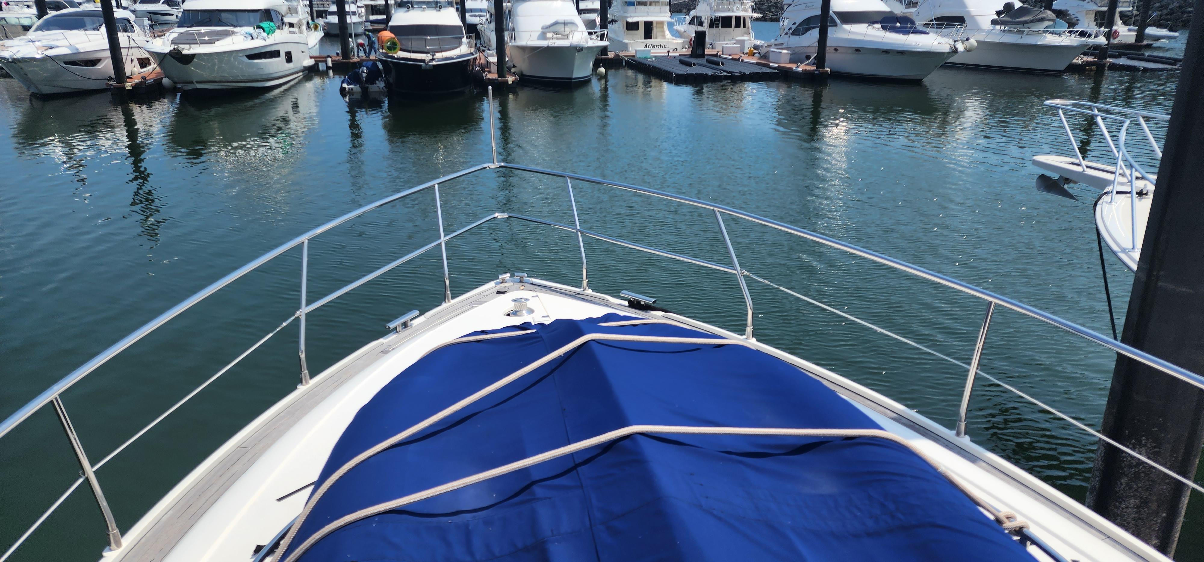 2007 Fairline Targa 52 GT yacht docked in marina, blue cover on deck.