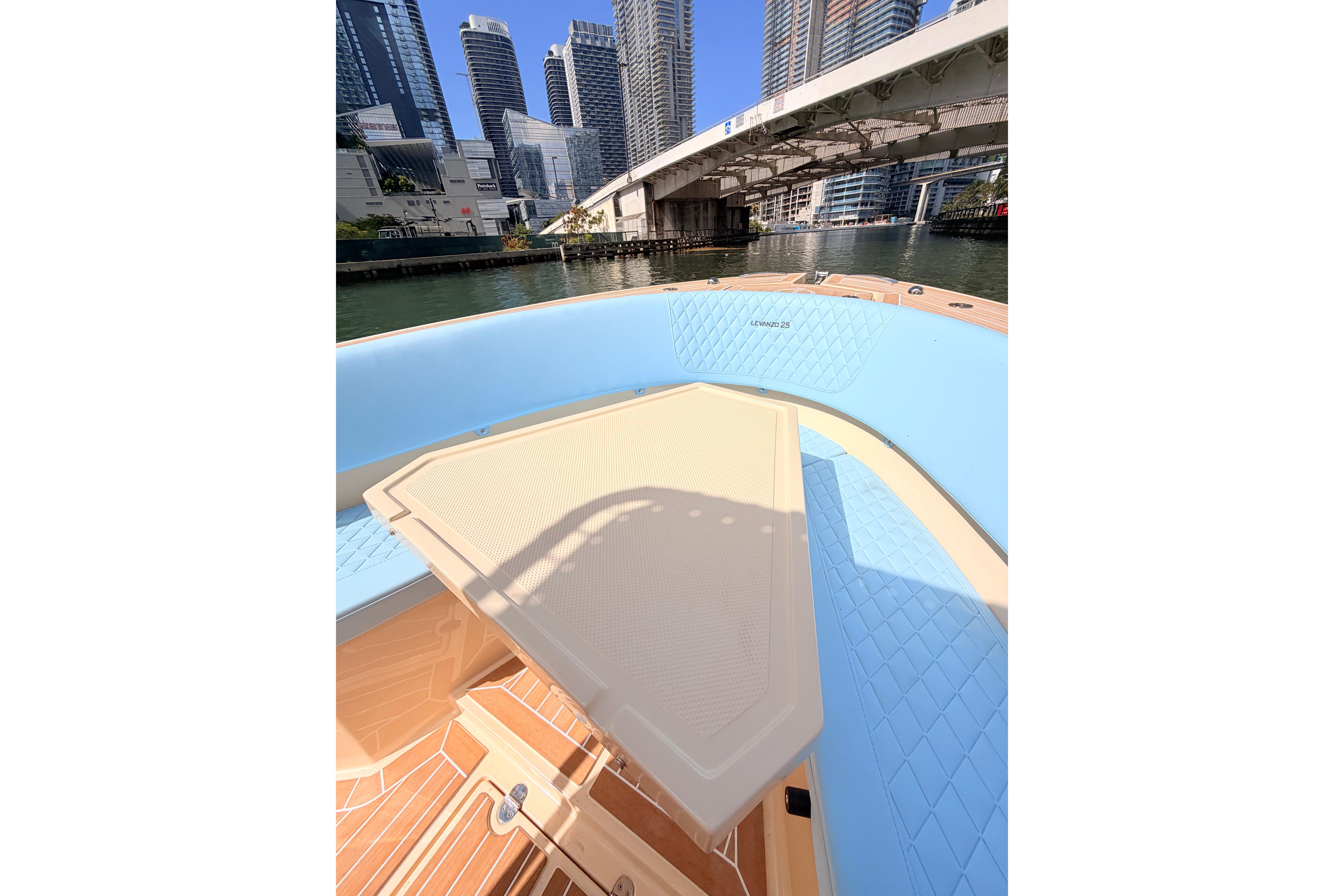 Lilybaeum Levanzo 25 boat interior with cityscape and bridge in the background, 2026 model.