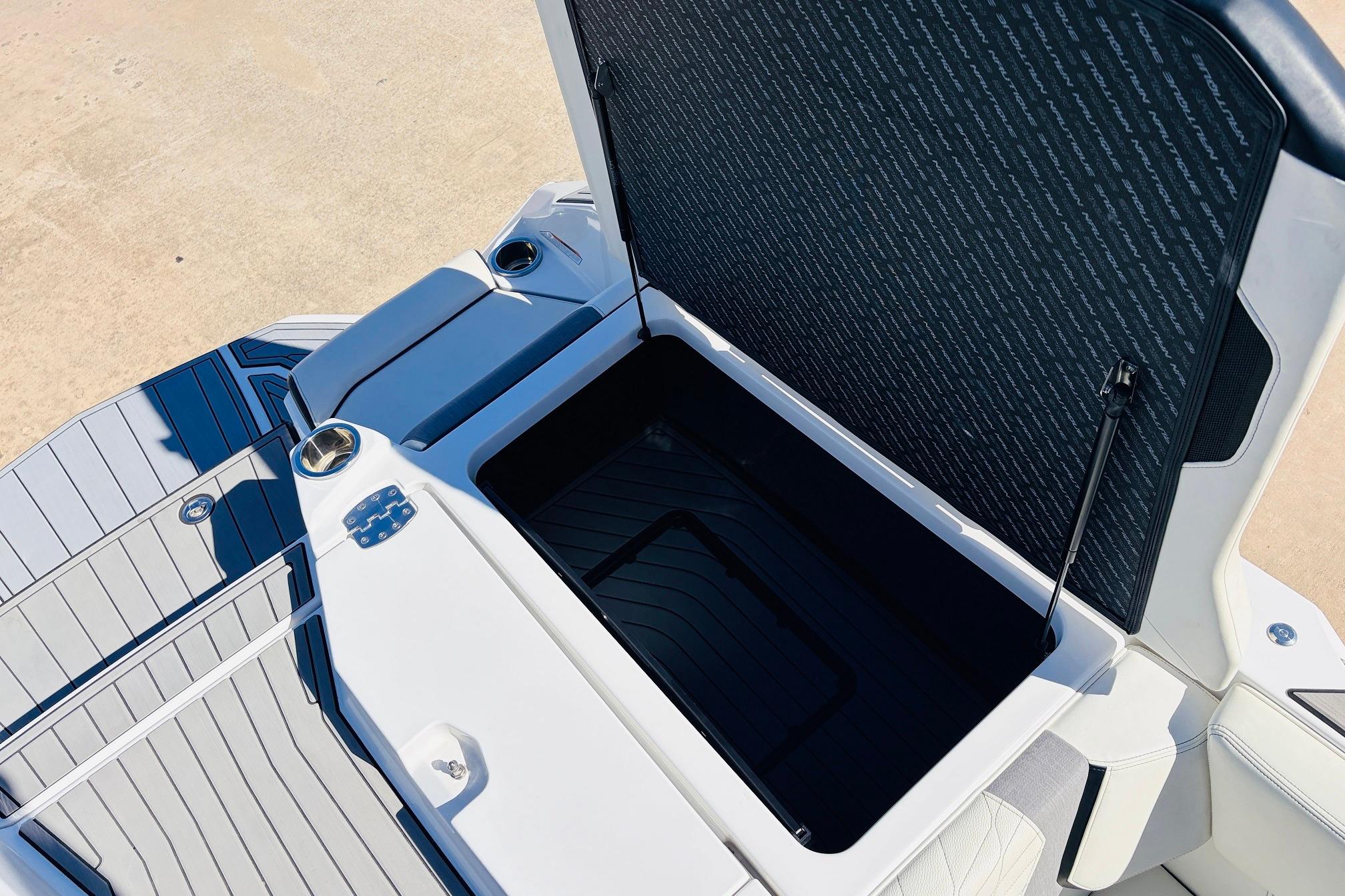 2023 Nautique Super Air Nautique G25 boat storage compartment open, showcasing interior space.