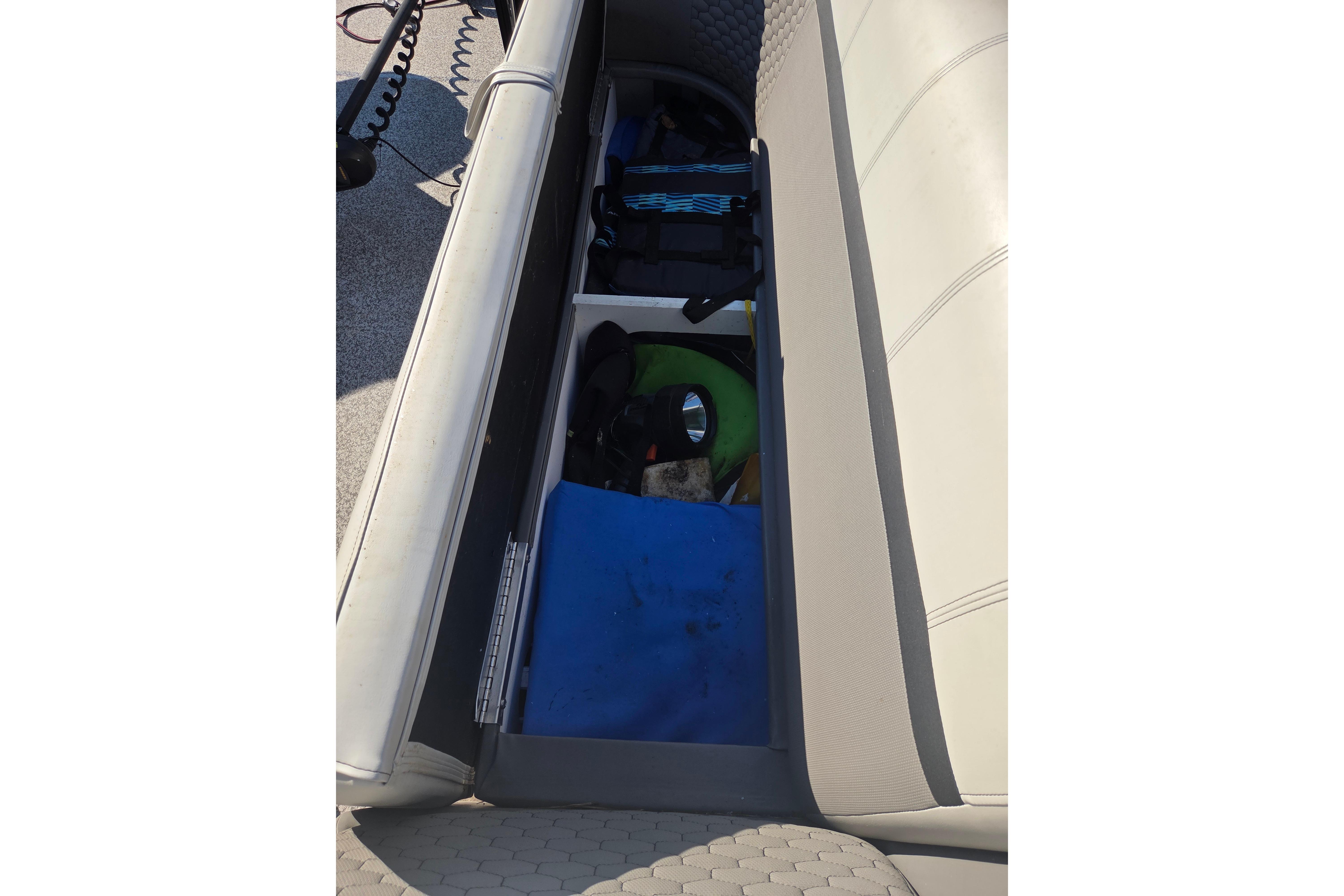 2024 Angler Qwest 8526 Pro Troll boat storage compartment with fishing gear.