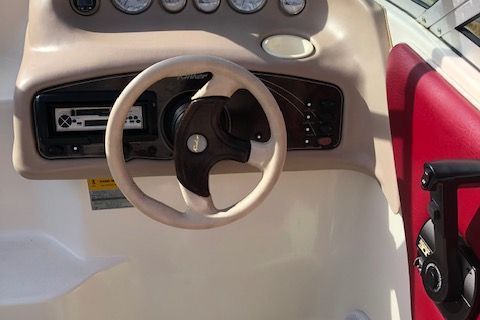 Steering console of a 1999 Rinker 212 Fiesta Vee boat.
