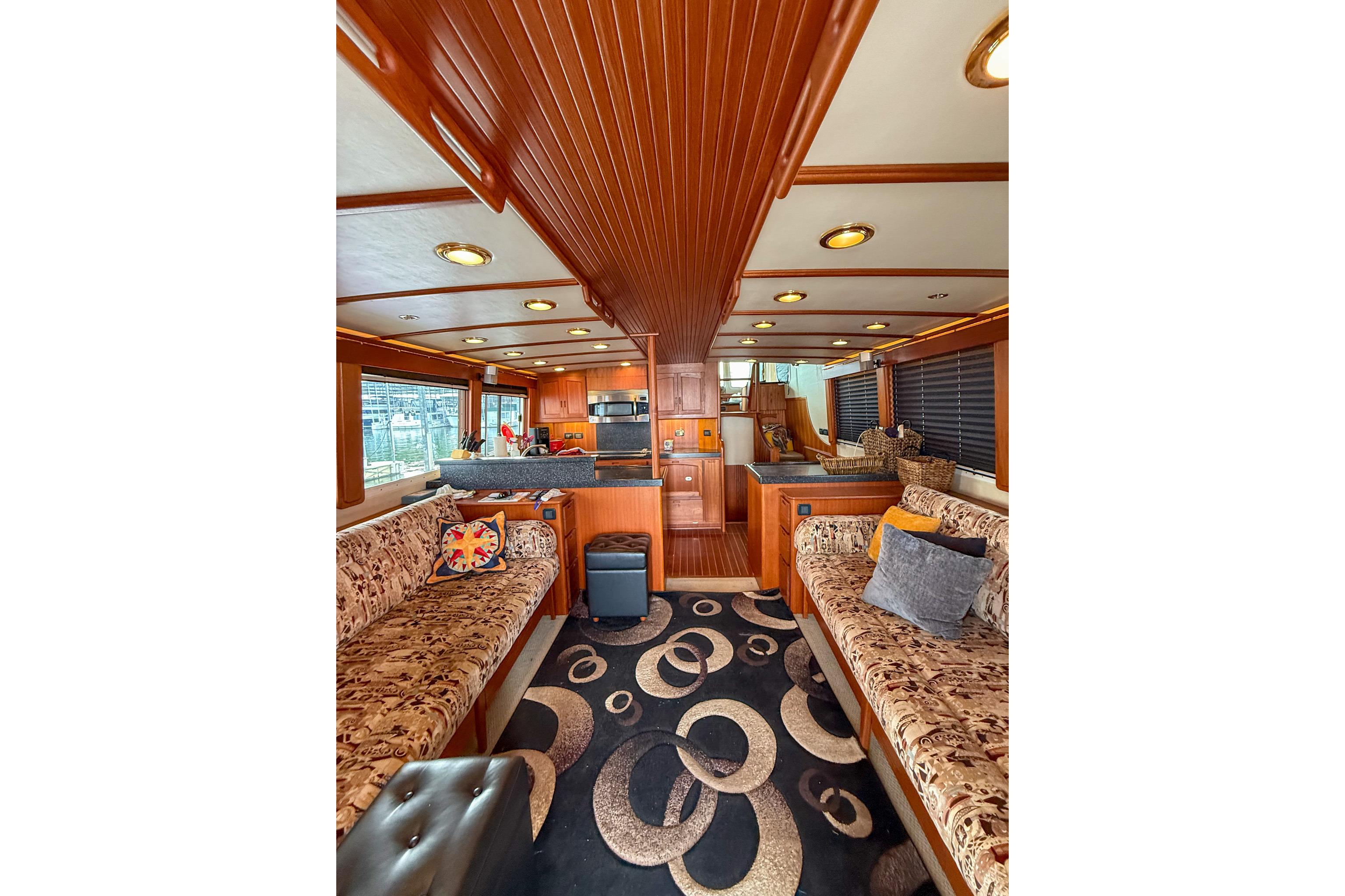 Luxurious interior of a 2007 Nordic Tug 54, featuring elegant wood finishes and plush seating.