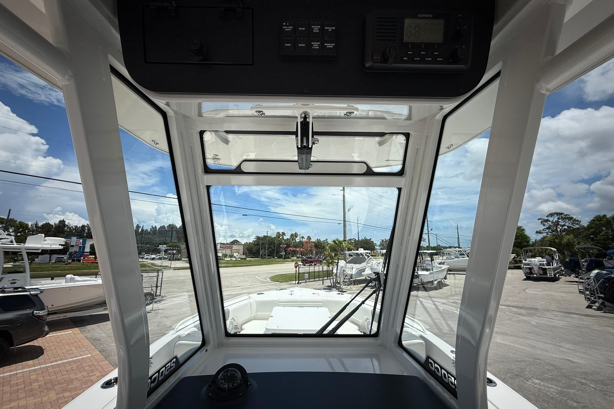 Interior view of 2026 Edgewater 250CC boat cockpit with clear windshield.