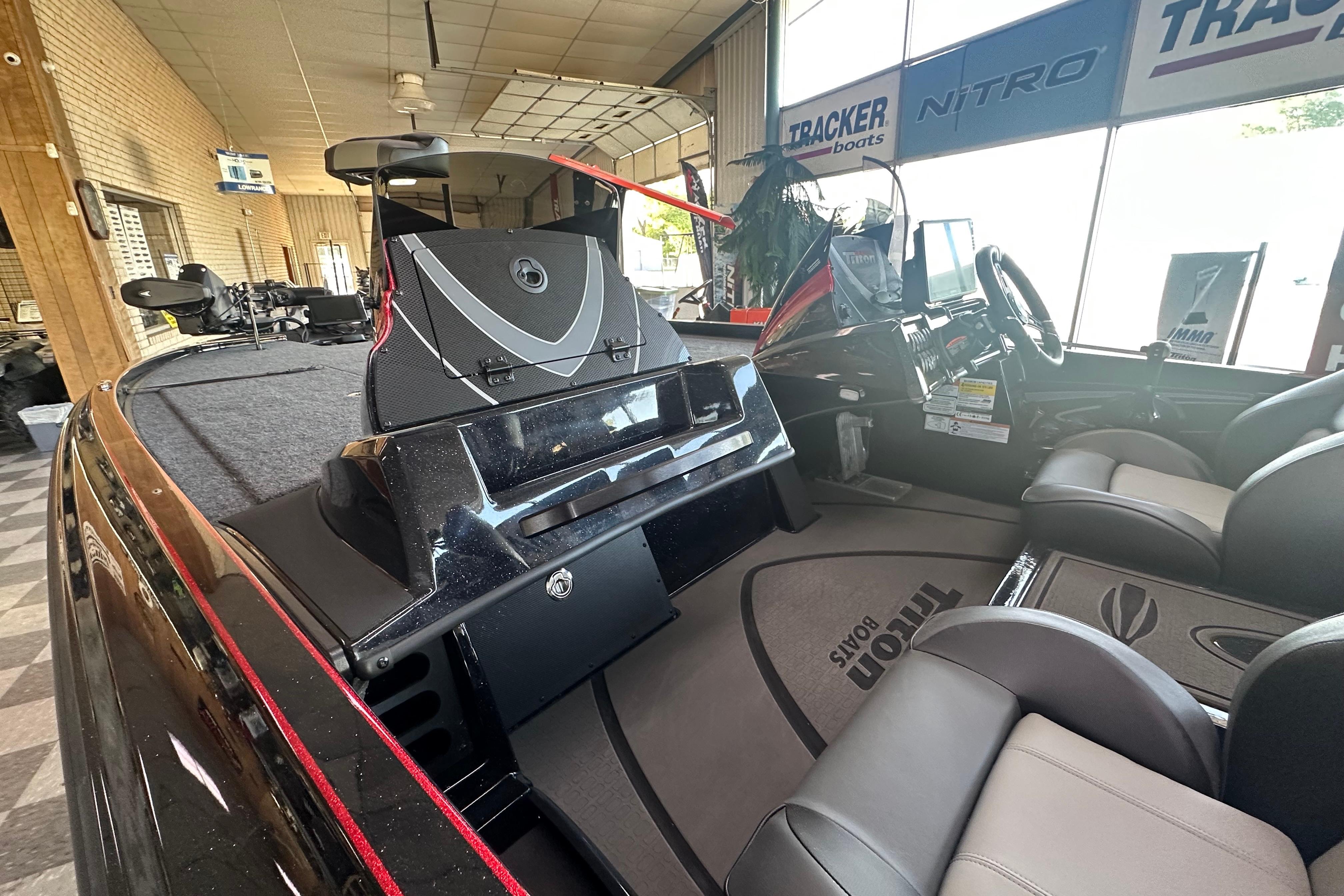 2026 Triton 20XP Patriot boat interior with seating and dashboard in showroom.