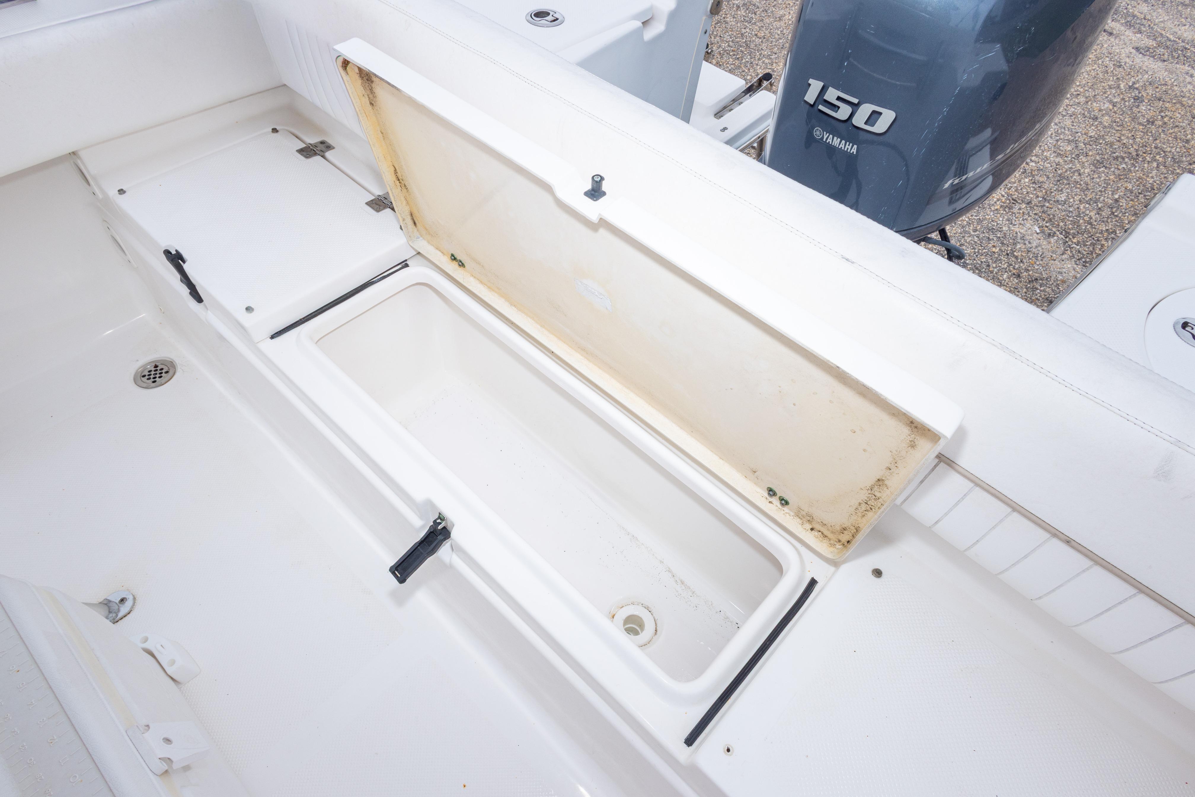 2014 Sea Fox 209 Commander boat with open storage compartment and Yamaha 150 engine.