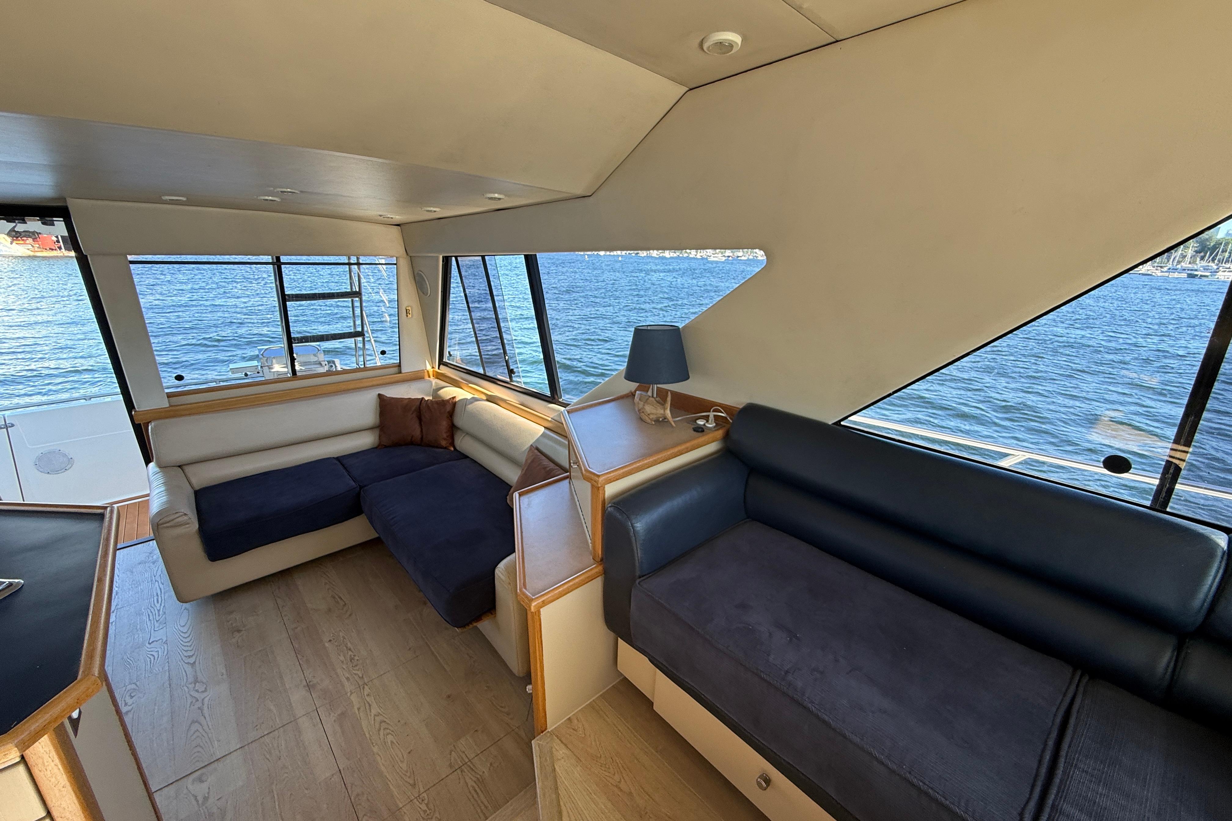 Interior of 1997 Bayliner 3988 Command Bridge Motoryacht with waterfront view.