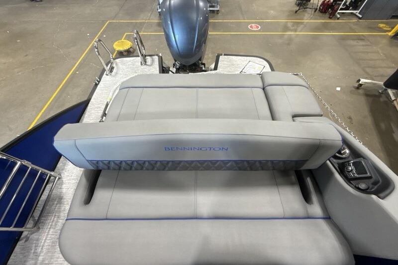 2026 Bennington 23 LXS Swingback boat interior with gray seating and motor view.
