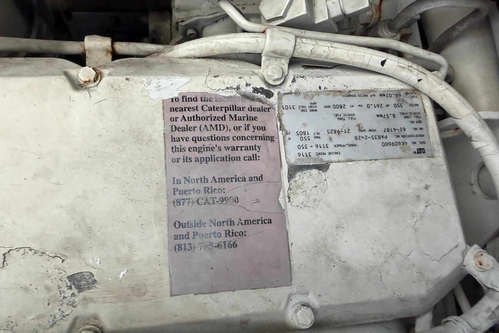 Engine compartment of a 2000 Sea Ray 410 Sundancer with Caterpillar warranty information.