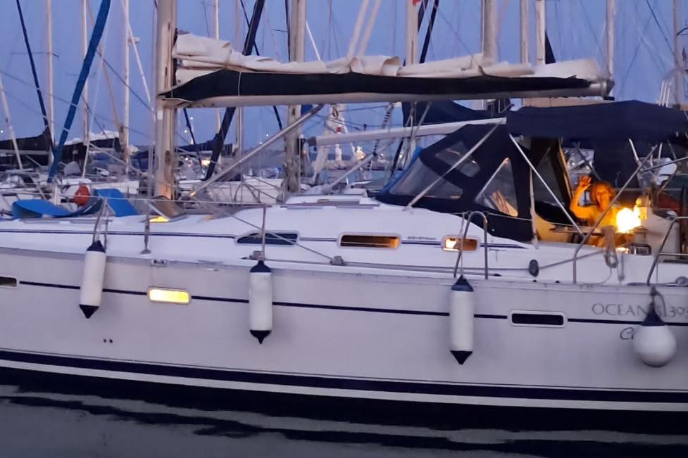 2002 Beneteau Oceanis Clipper 393 sailboat docked at marina during twilight.