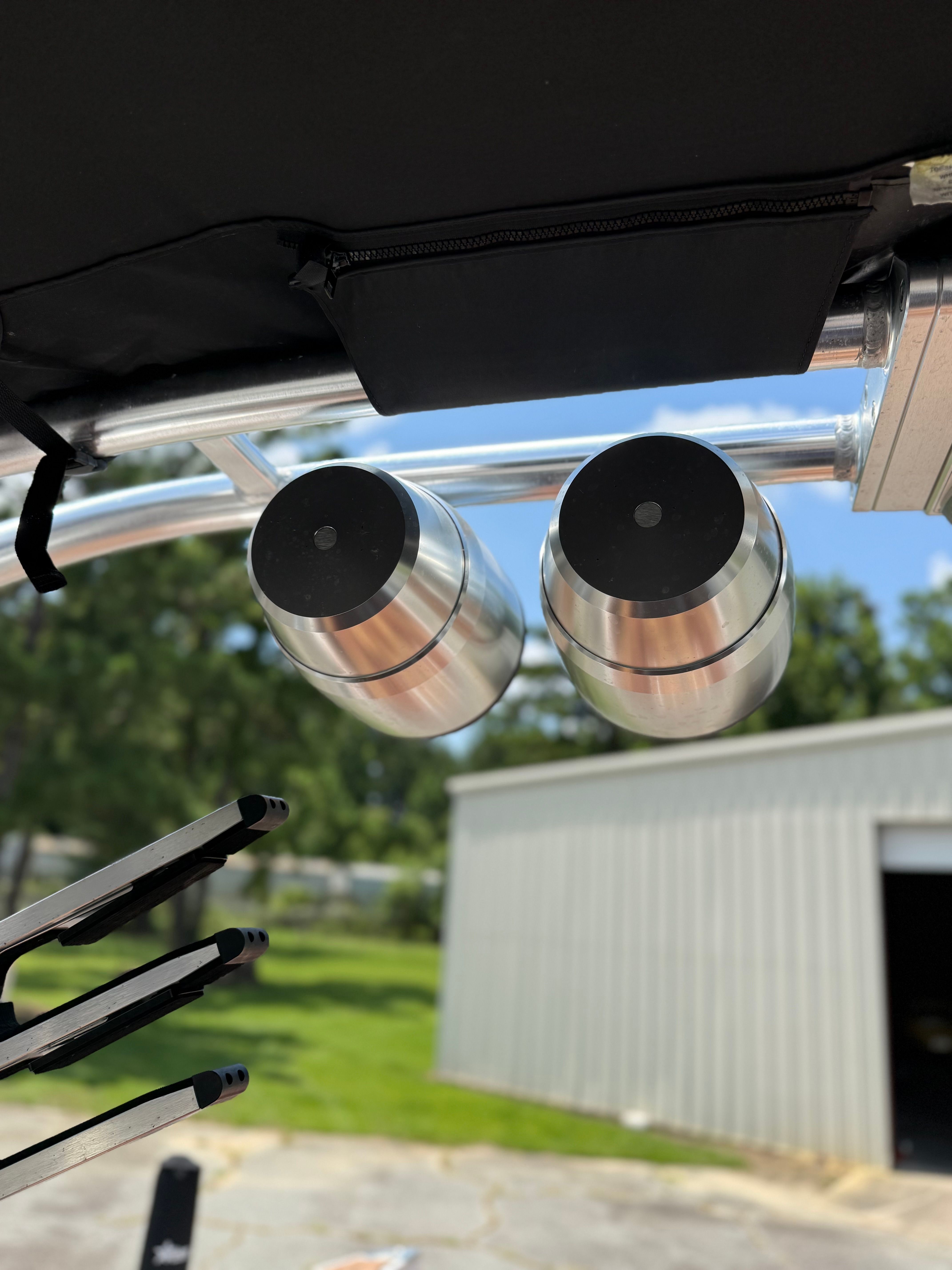 Close-up of two silver speakers on a boat.