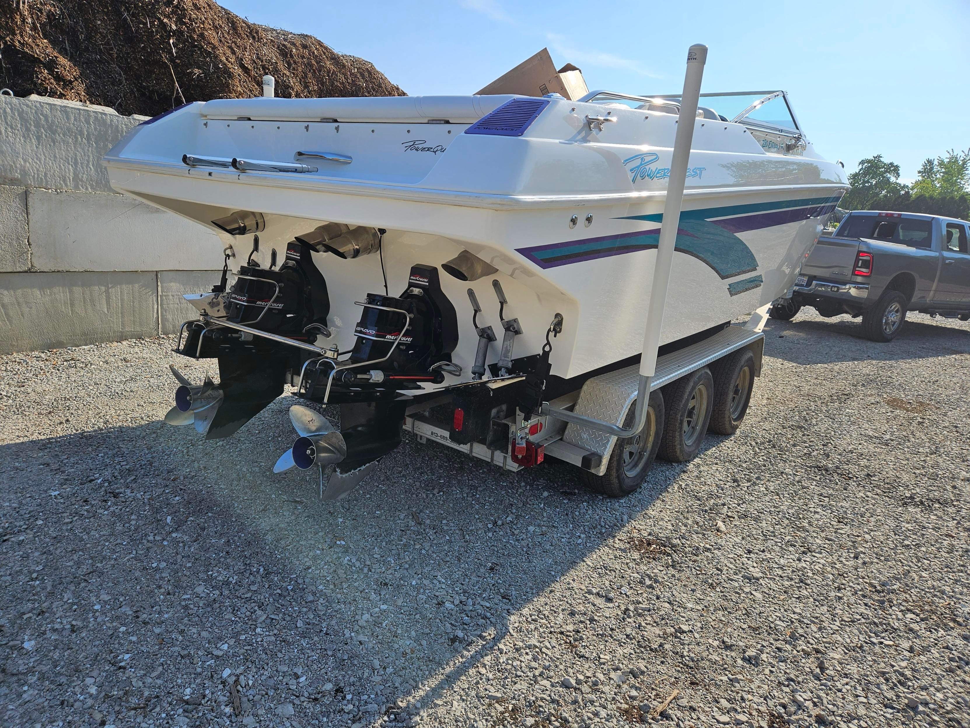1998 Powerquest Enticer 290 FX on a trailer, featuring dual outboard engines.