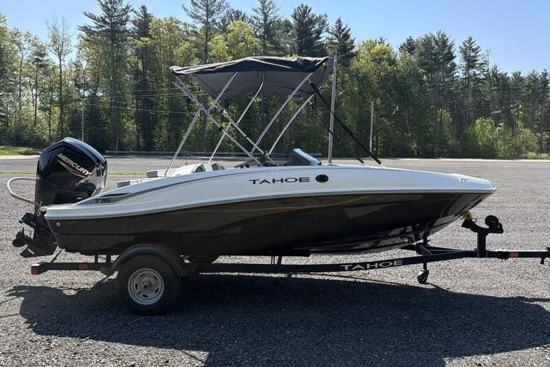 2026 Tahoe T16 boat on trailer with canopy, parked outdoors.