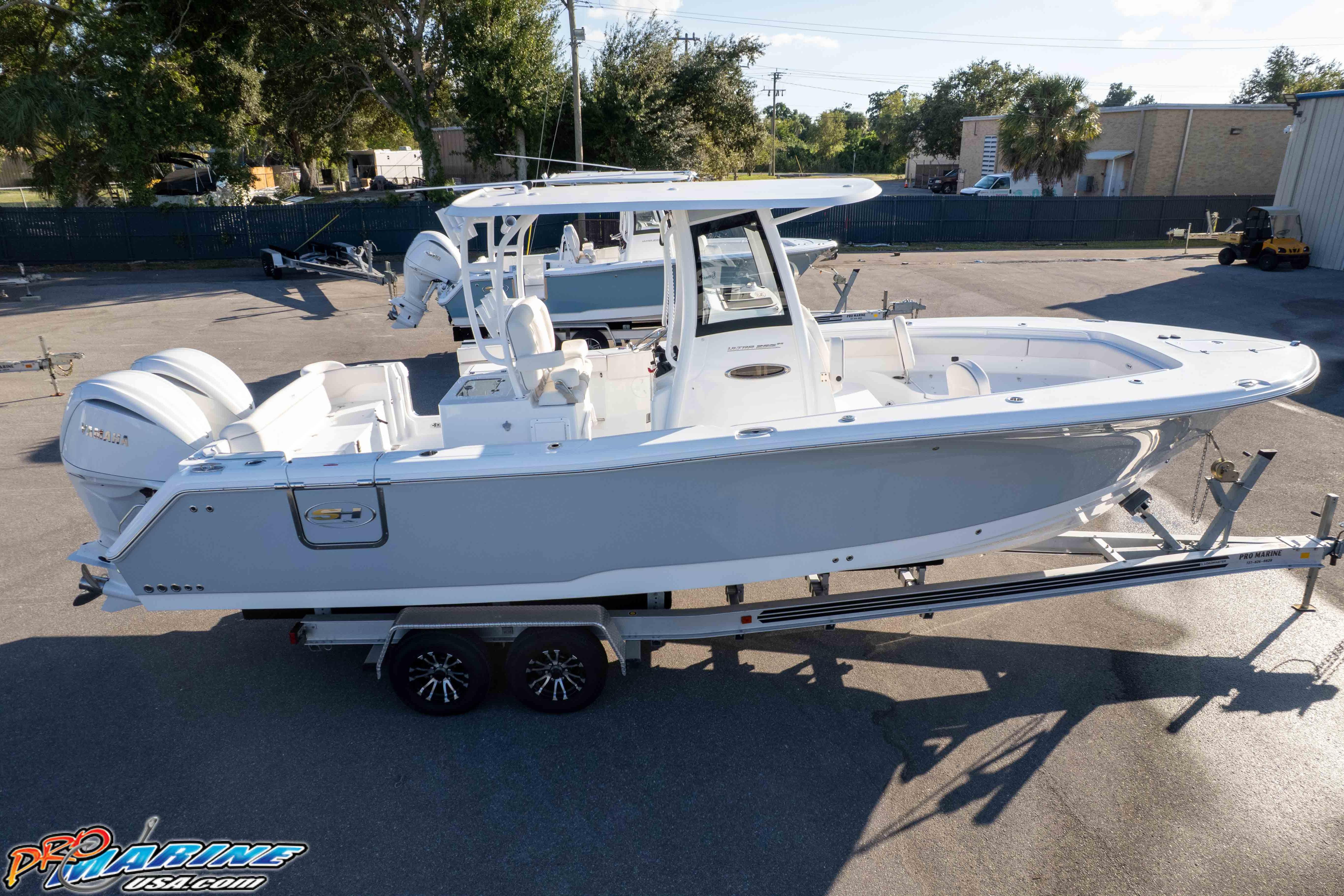 2026 Sea Hunt Ultra 285 SE boat on trailer, parked outdoors.