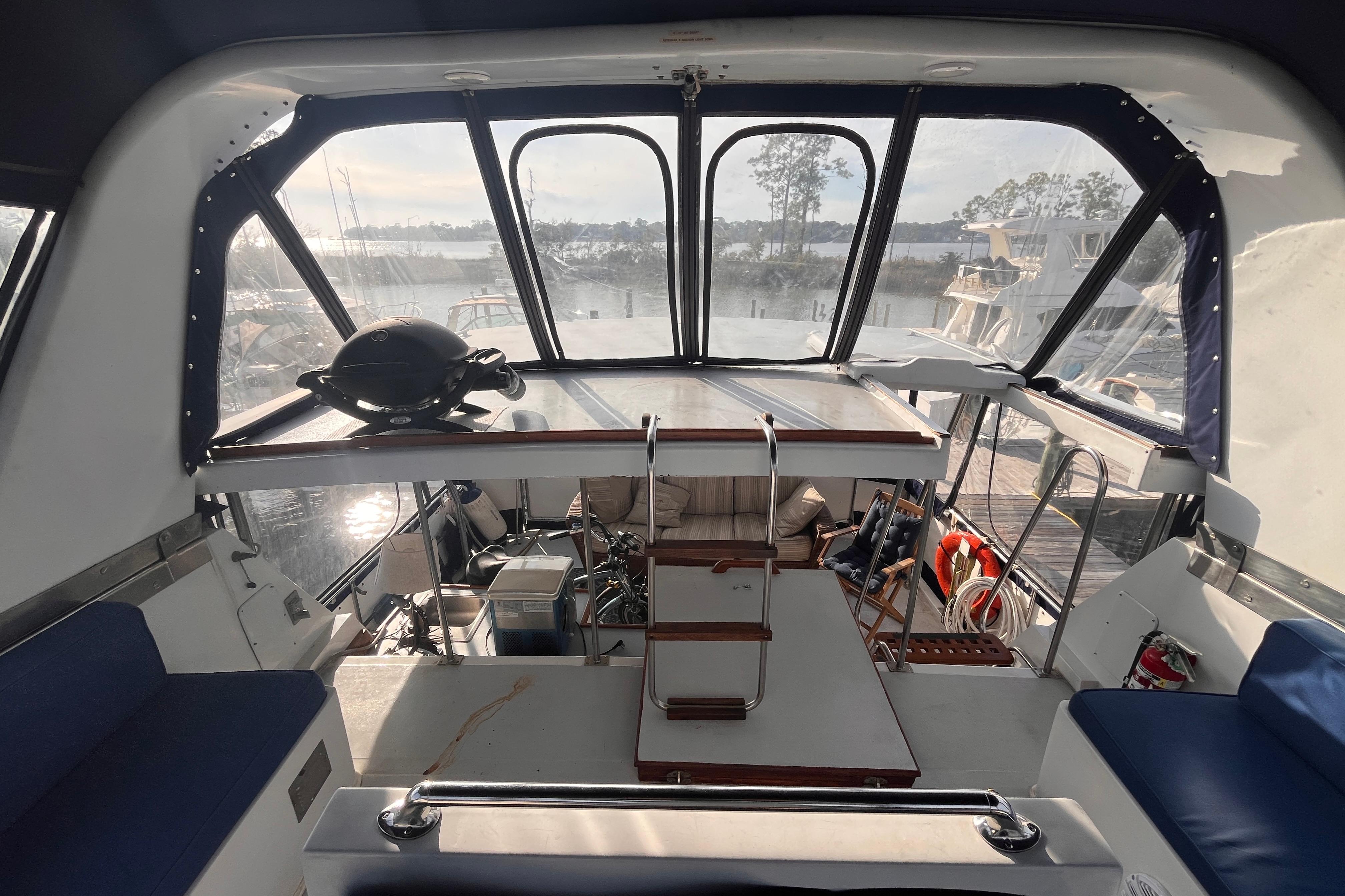Interior view of 1986 Jefferson 42 SE Sundeck Motor Yacht with seating and helm.