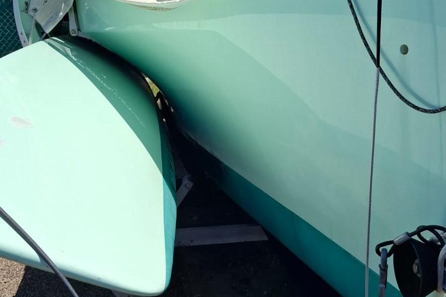 Close-up of a 2011 Custom Melvest Marine F-22 boat hull in light teal.