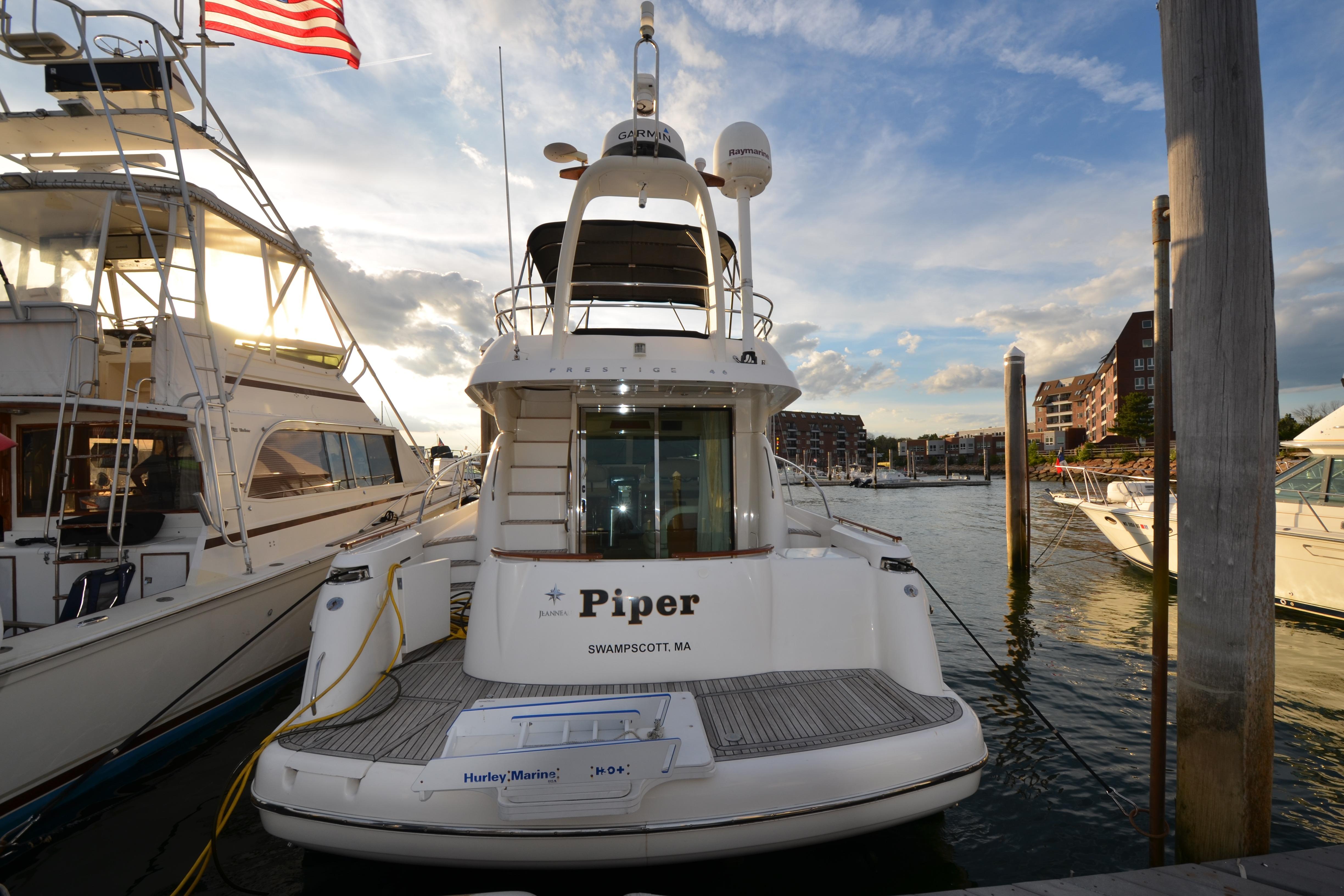 2007 Jeanneau Prestige 46 yacht docked at marina, sunset view.