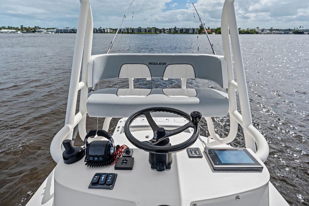 2018 Regulator 41 boat helm with steering wheel and controls on open water.