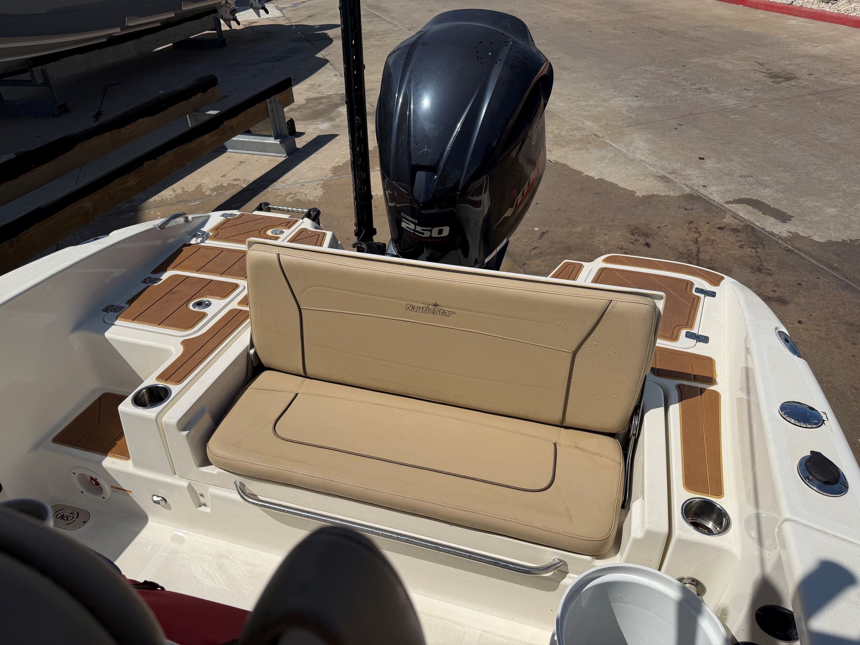 2019 NauticStar 251 Hybrid boat with outboard motor and seating.