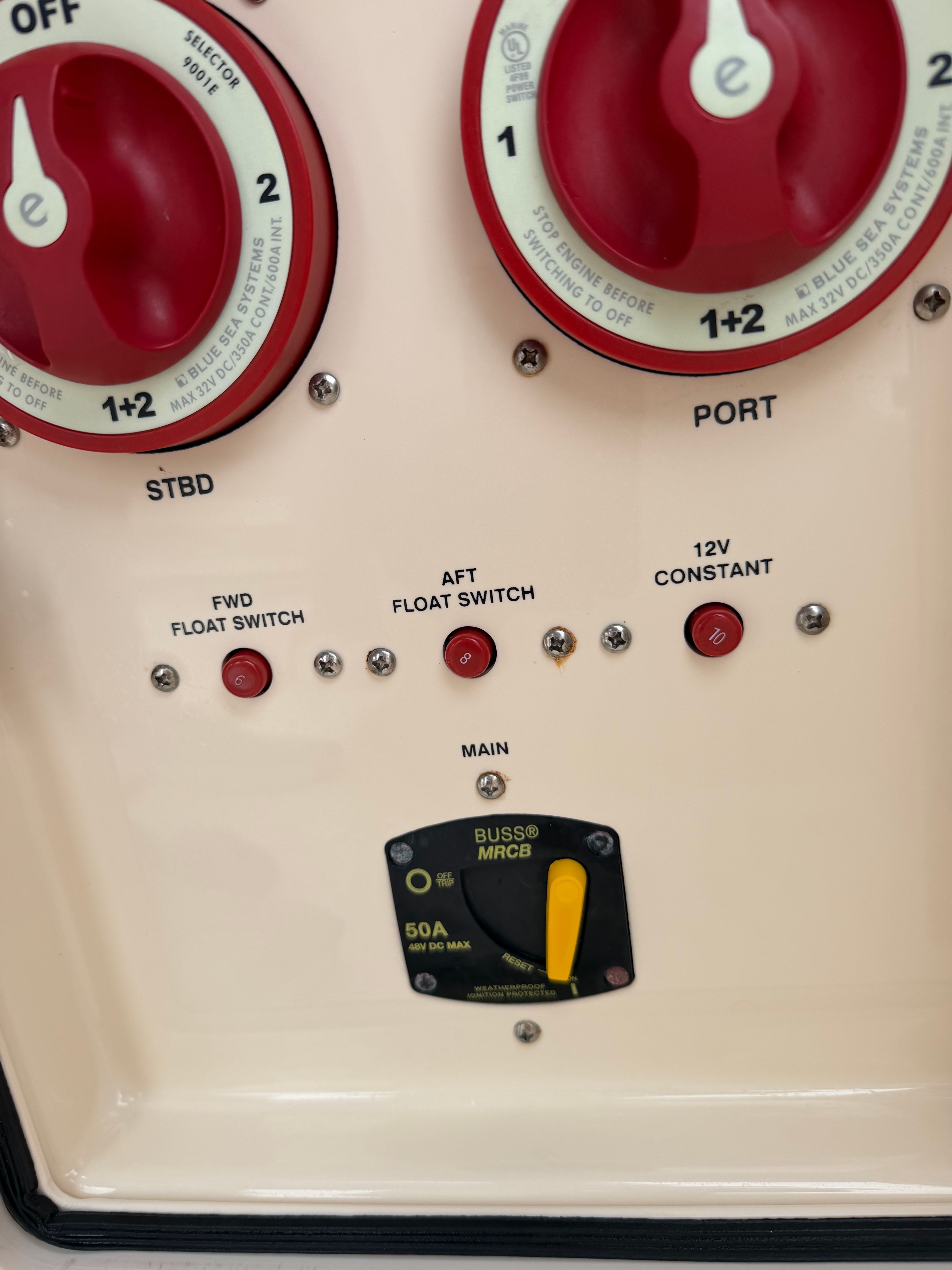 Close-up of a boat control panel with switches and indicators.