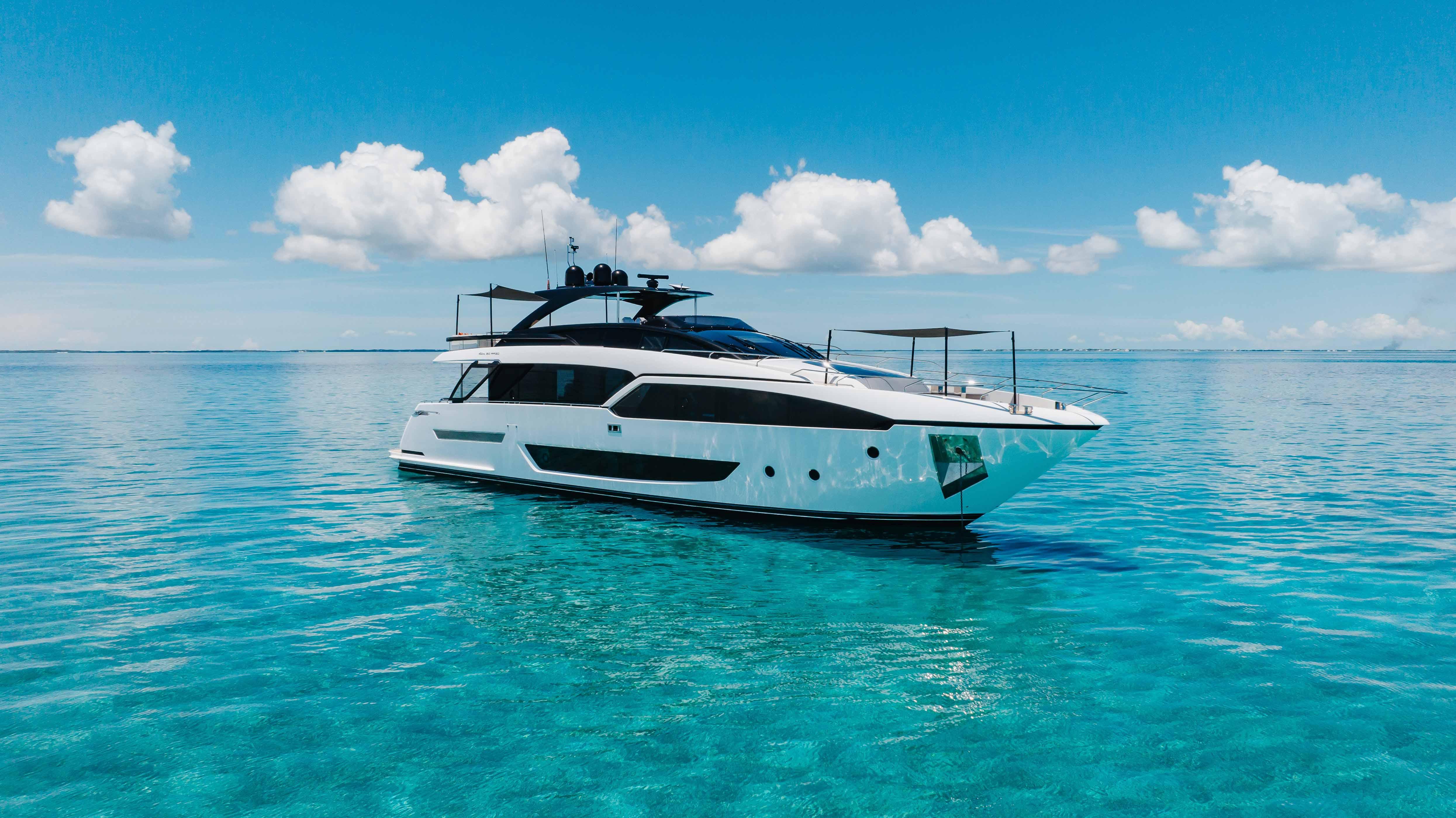 Luxury 2020 Riva 90 Argo yacht on clear blue ocean under a bright sky.