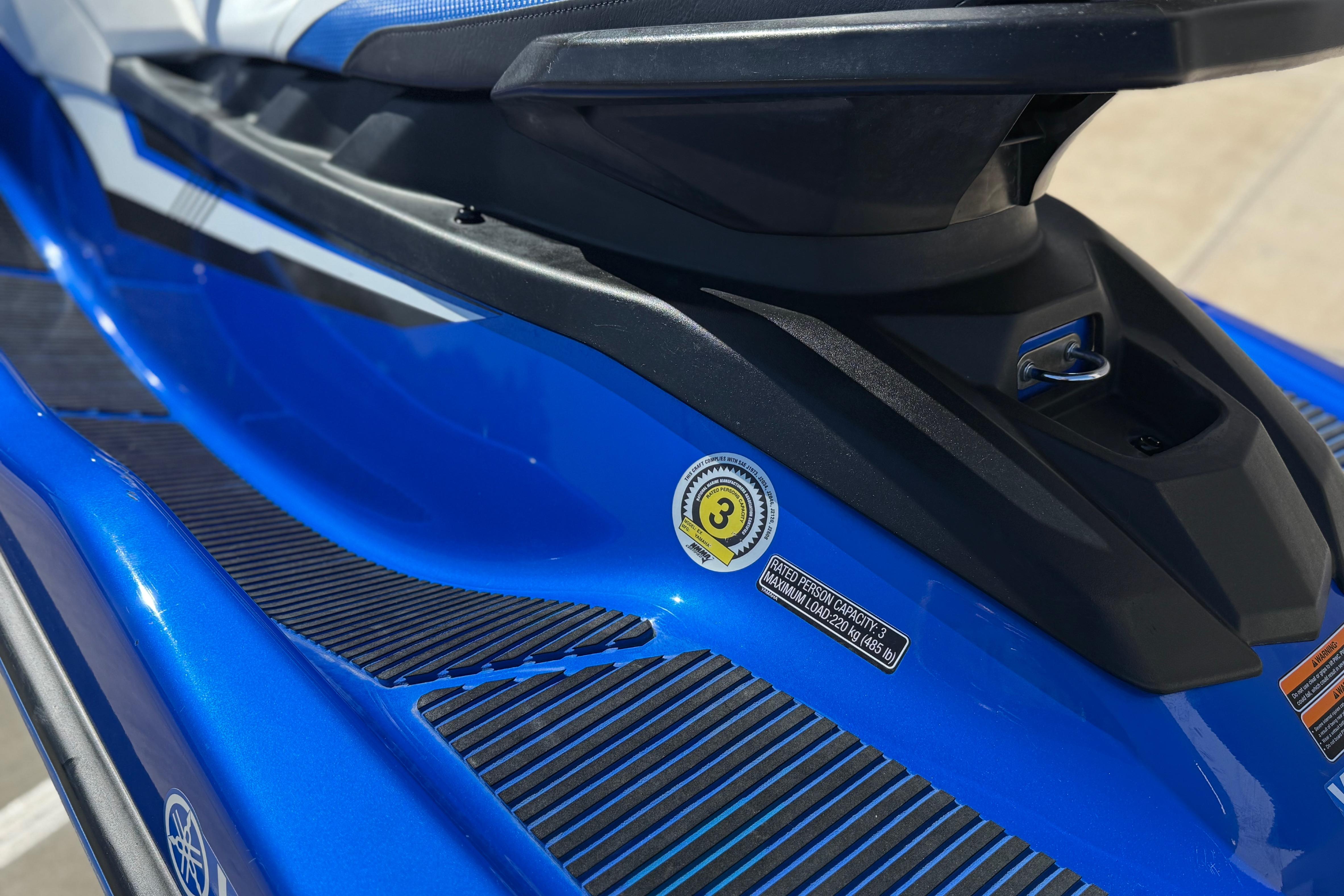 Blue 2017 Yamaha WaveRunner EX Deluxe jet ski with safety and capacity labels.