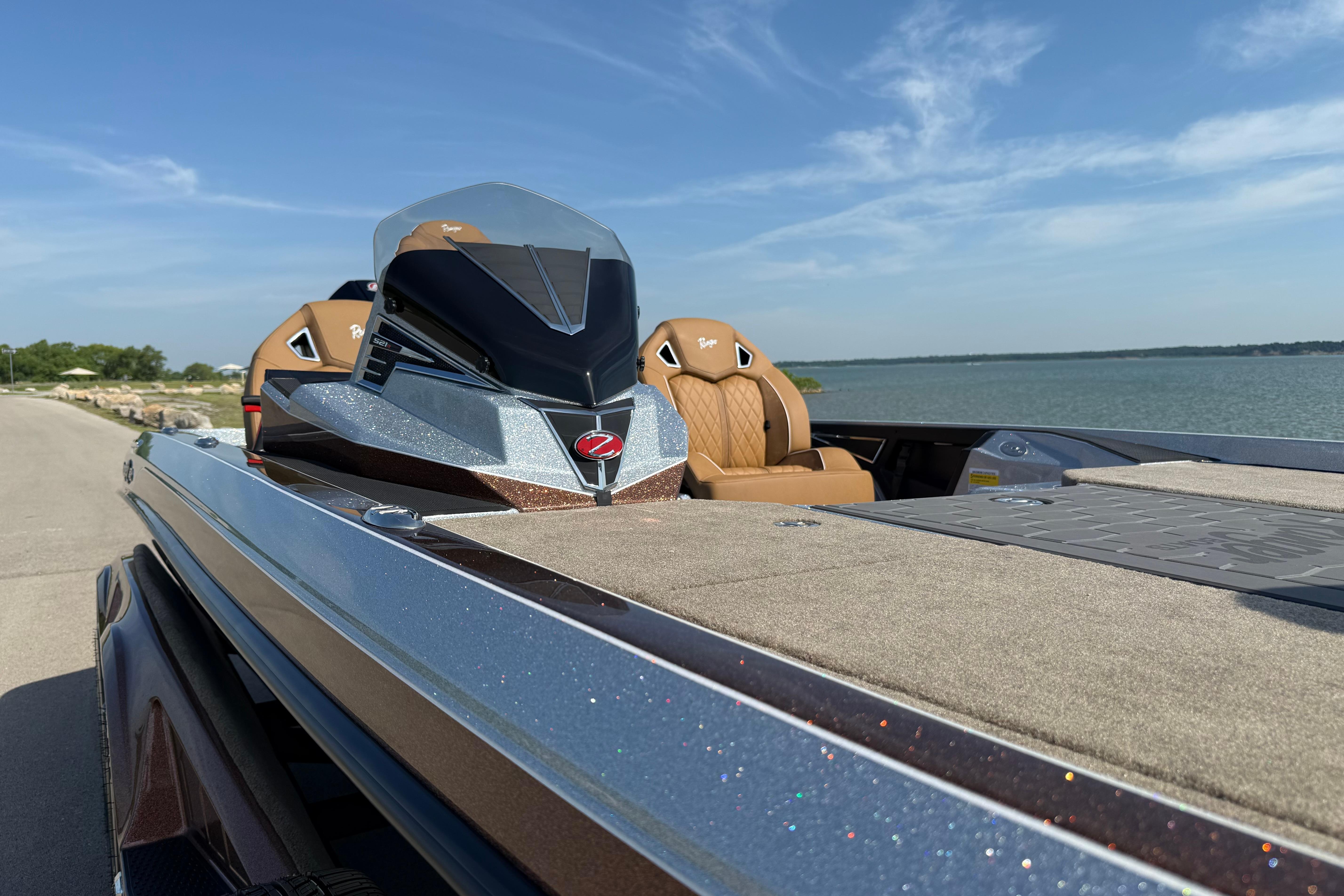 2026 Ranger Z521R boat with sleek design, tan seats, and lake backdrop.