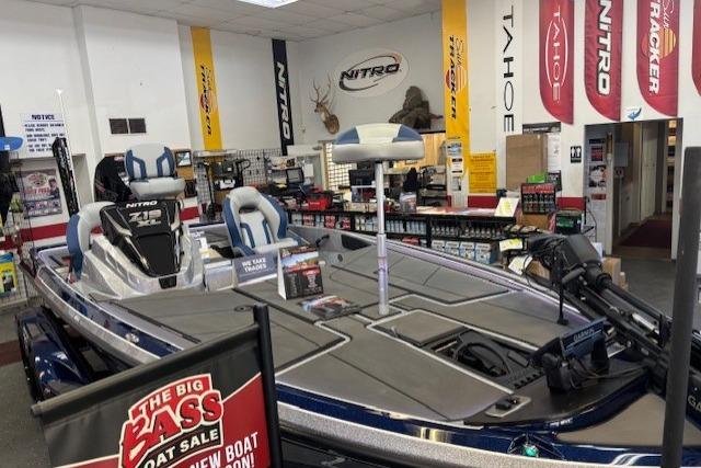 2026 Nitro Z19 XL boat displayed in showroom with promotional banners and accessories.
