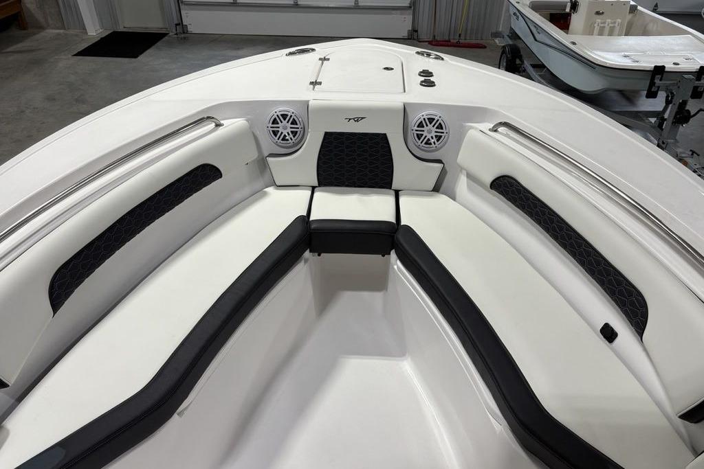 2026 Tidewater 232 CC Adventure boat interior with cushioned seating and speakers.