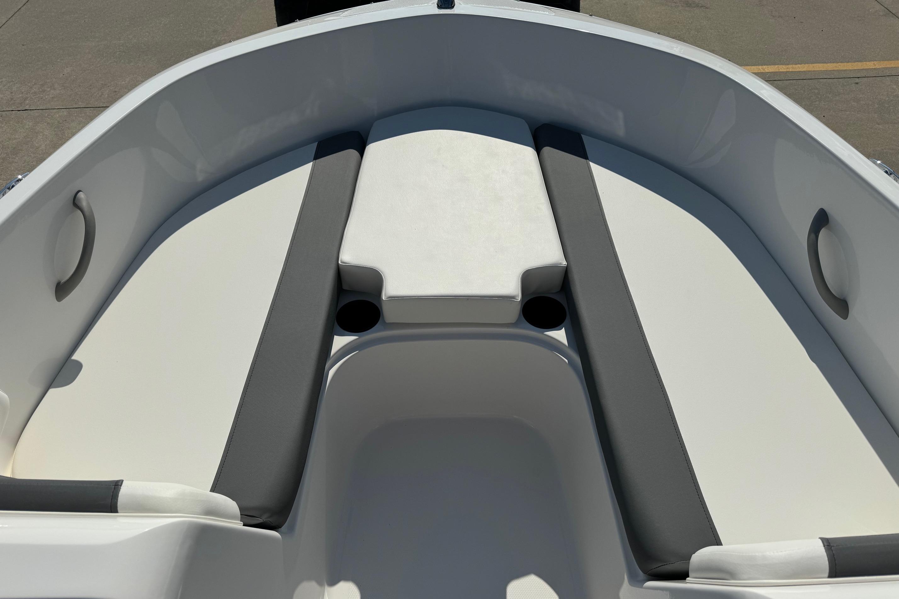 2025 Bayliner Element E16 boat interior with cushioned seating and cup holders.