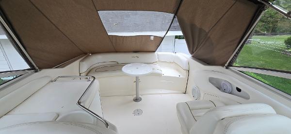 1999 Sea Ray 280 SS boat interior with seating and table under a canopy.