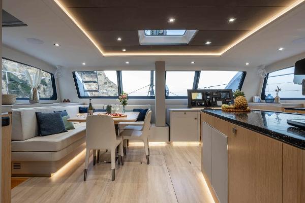 Luxurious interior of 2025 Privilege Signature 580 yacht with modern dining and kitchen area.