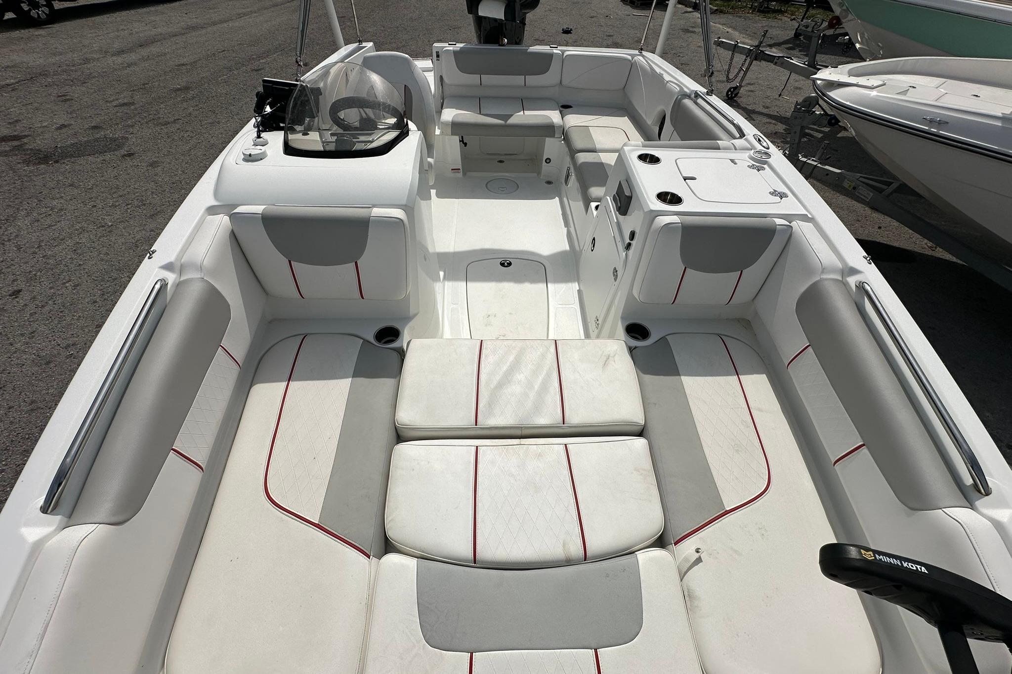 2021 Tahoe 2150 boat interior with white and gray seating, red accents, and steering console.