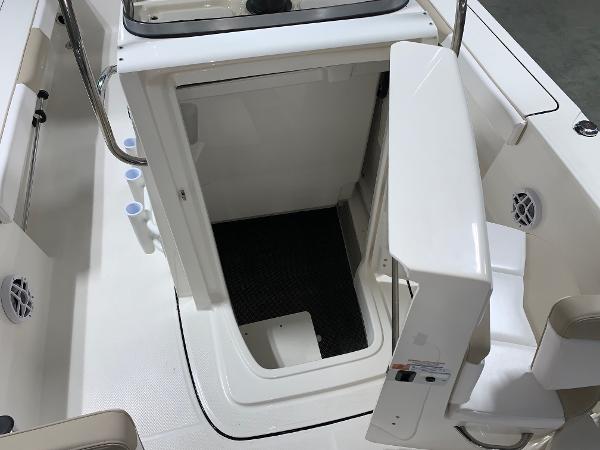 2026 Robalo 226 Cayman boat storage compartment with open hatch and seating area.