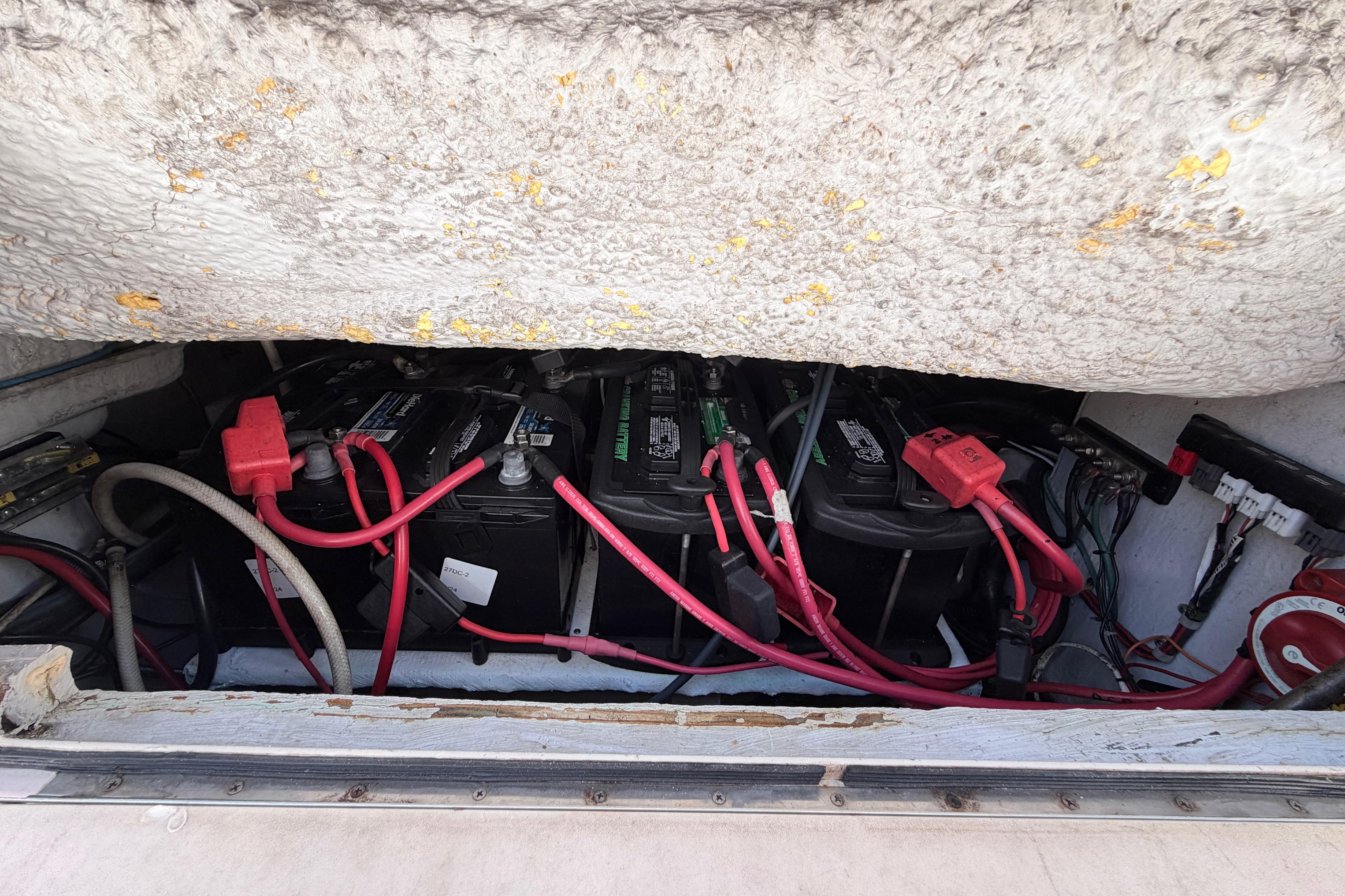 Battery compartment of a 2006 Grady-White Sailfish 282 with visible wiring and connections.