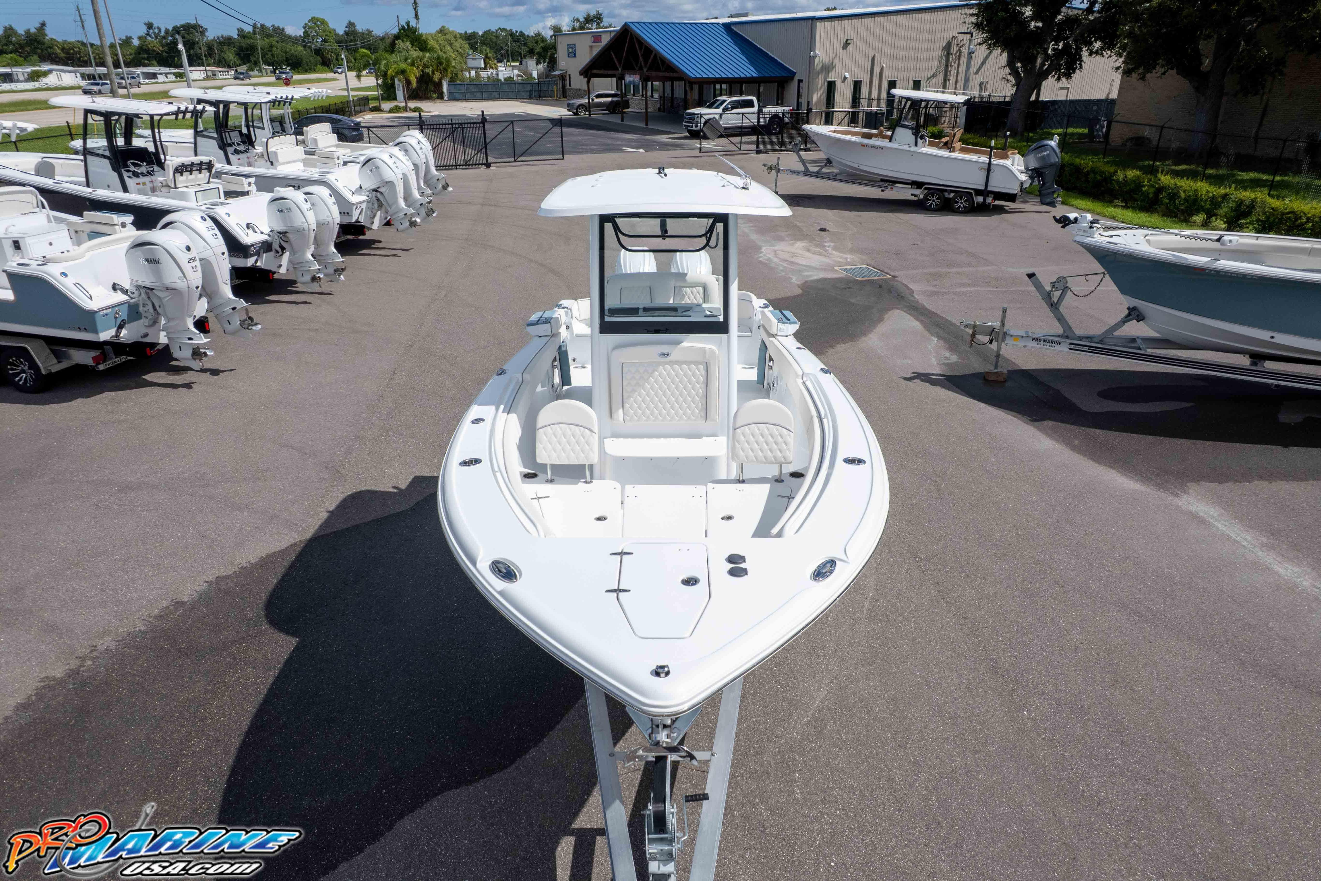2026 Sea Hunt Ultra 265 SE boat displayed at a dealership, surrounded by other boats.