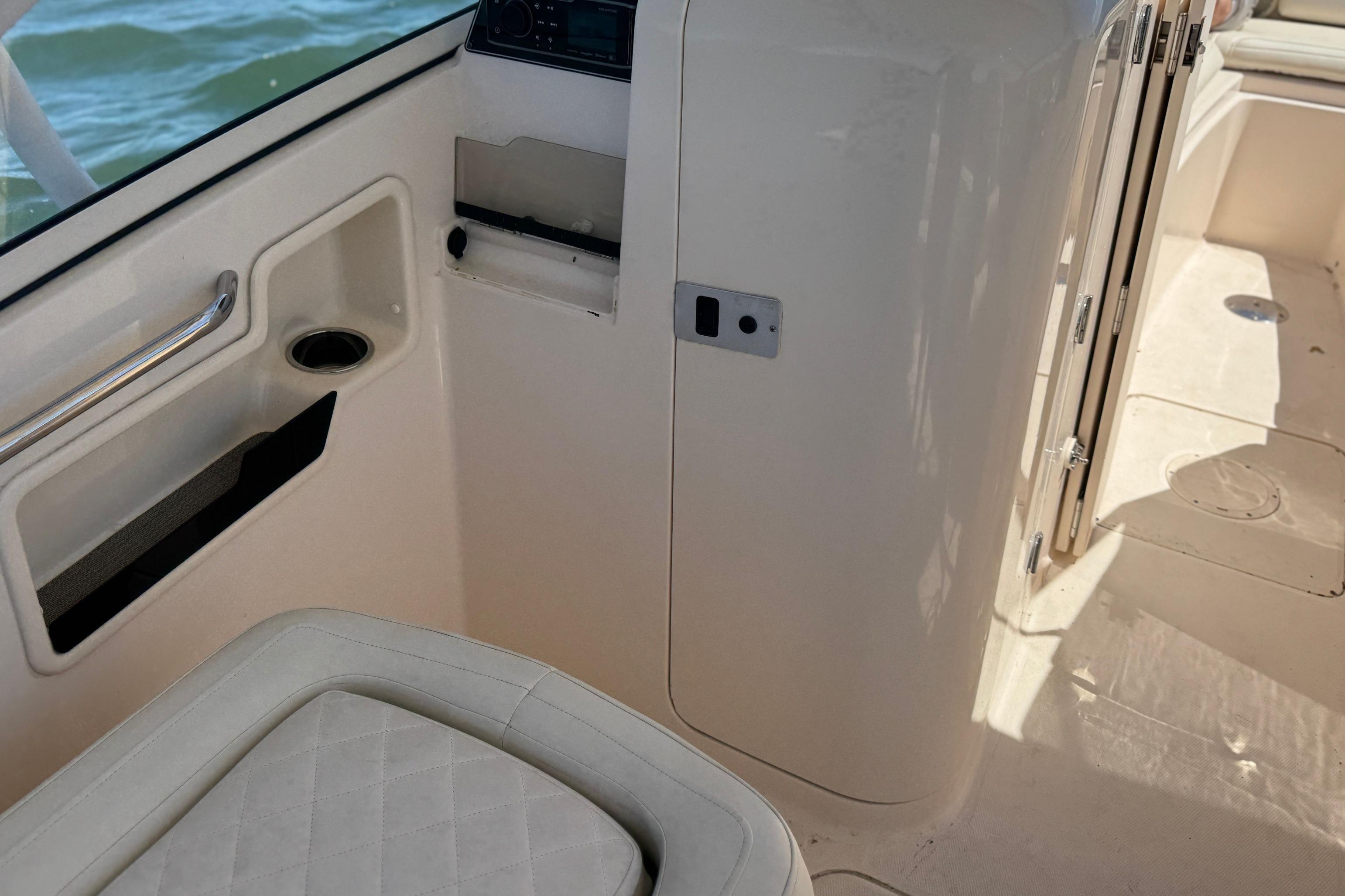 Interior of 2017 Grady-White Freedom 235 boat, featuring seating and storage.