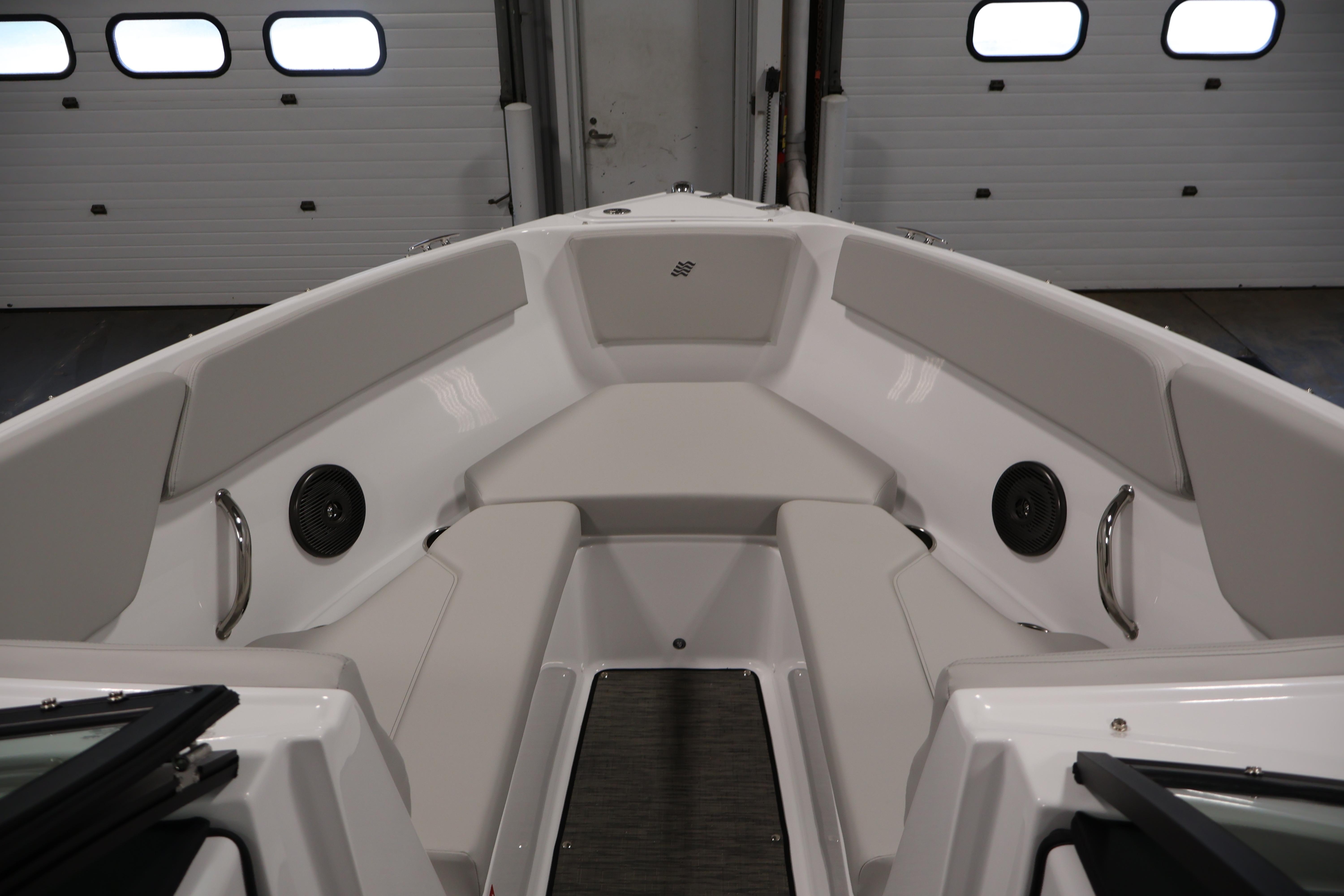 2026 Four Winns H4 Freedom boat interior with cushioned seating and speakers.