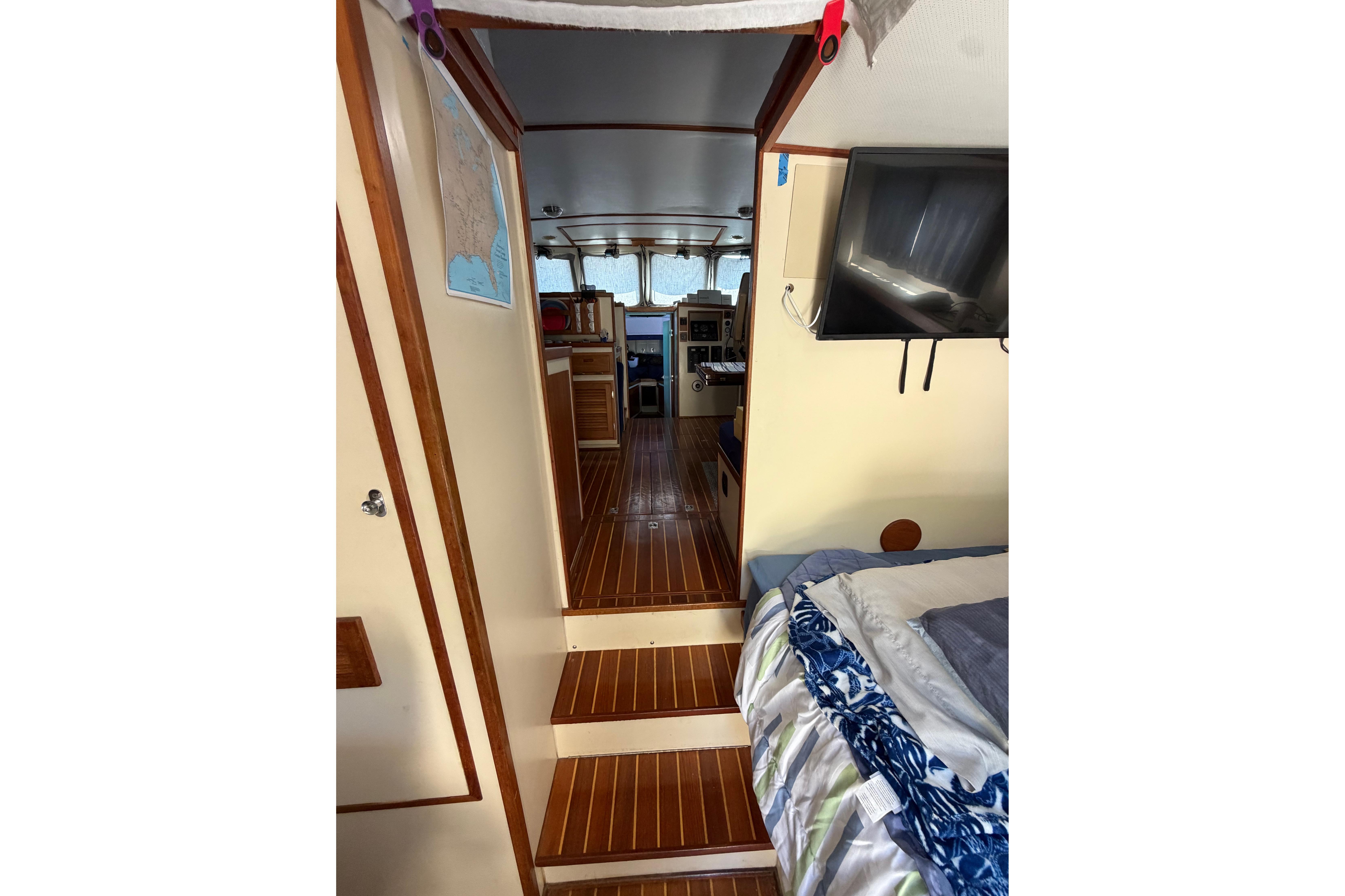 Interior of a 1997 Rosborough Trawler with wood flooring and cozy cabin space.