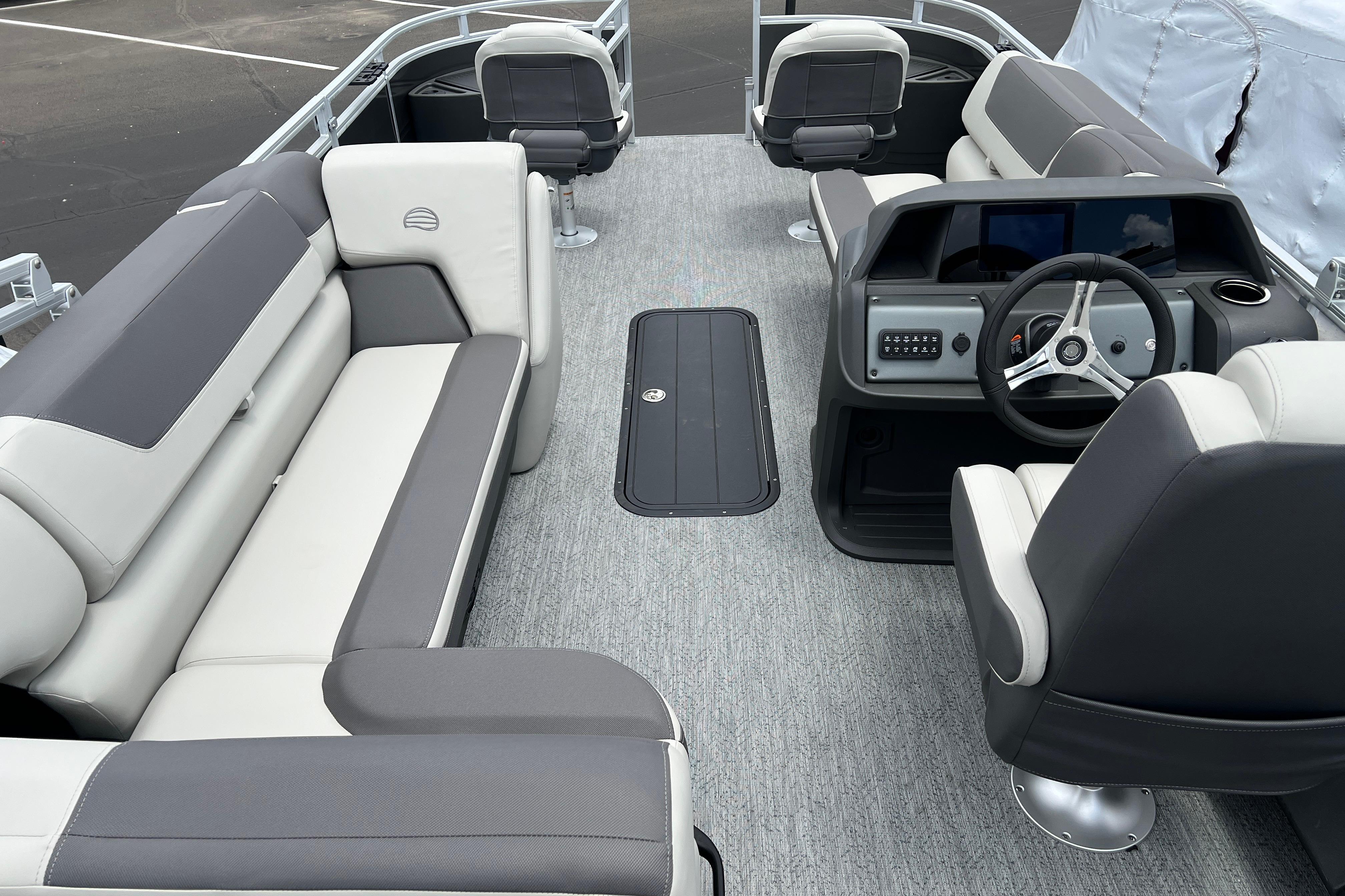 2026 Sun Tracker Fishin' Barge 22 XP3 interior with plush seating and modern helm.