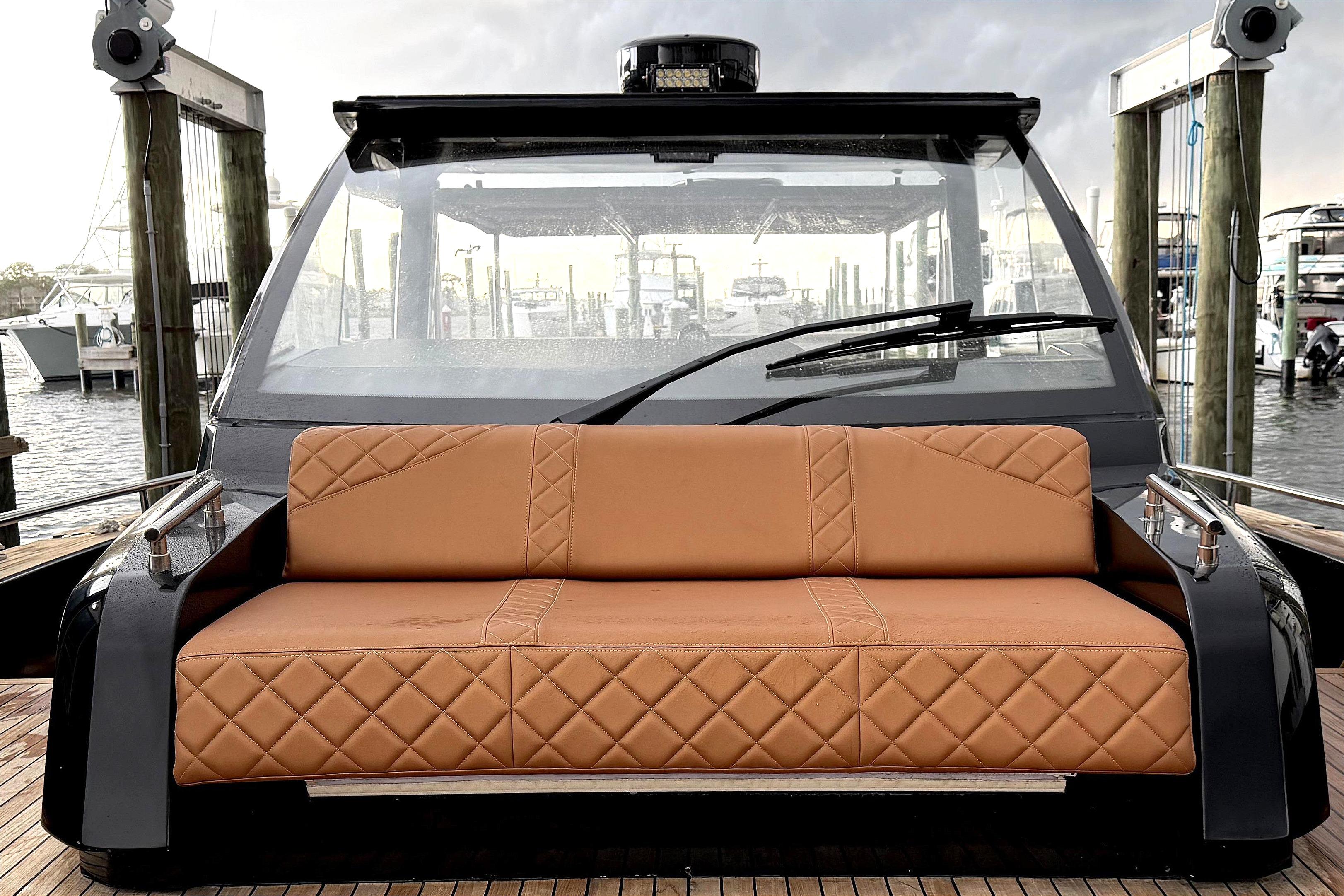 Luxurious 2013 Windy SR52 yacht with elegant tan seating and sleek wooden deck.
