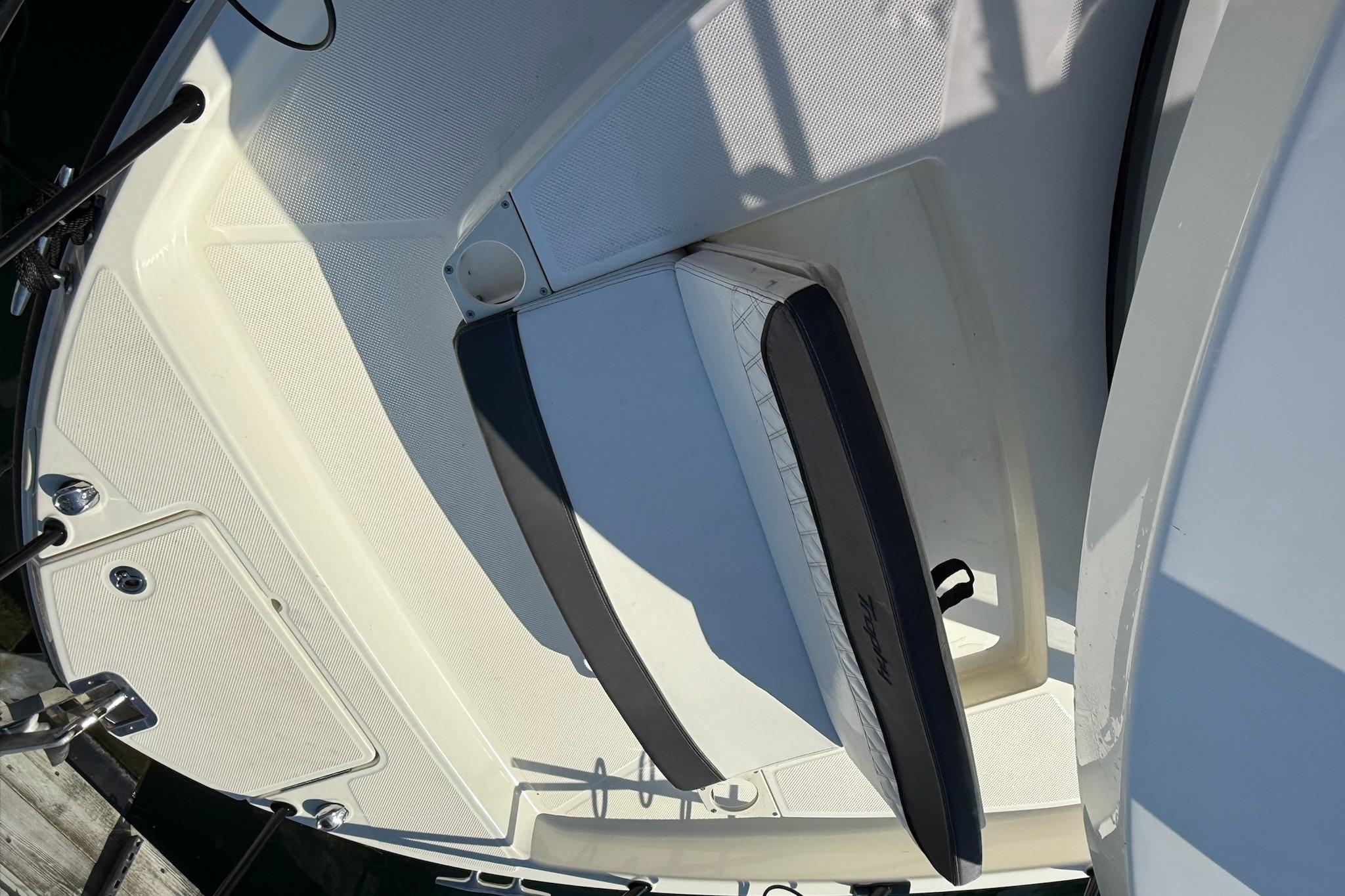 2024 Bayliner Trophy T25 Pilothouse boat deck with seating and storage compartments.