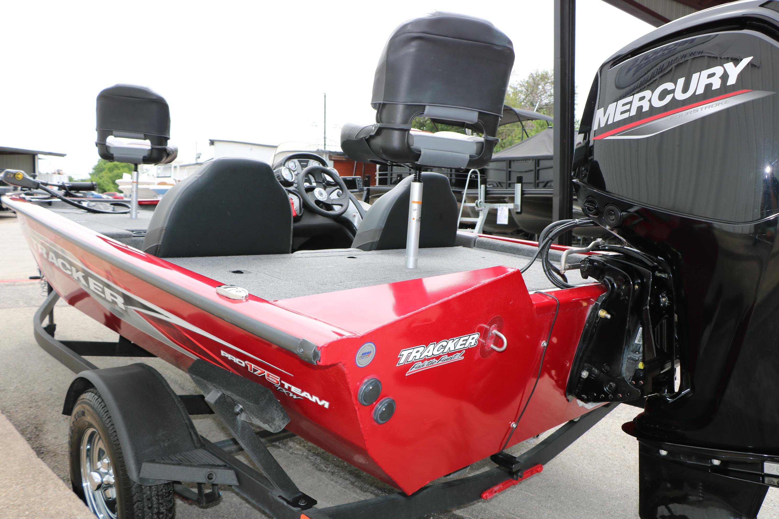 2024 Tracker Pro Team 175 boat with Mercury engine, red exterior, parked on trailer.
