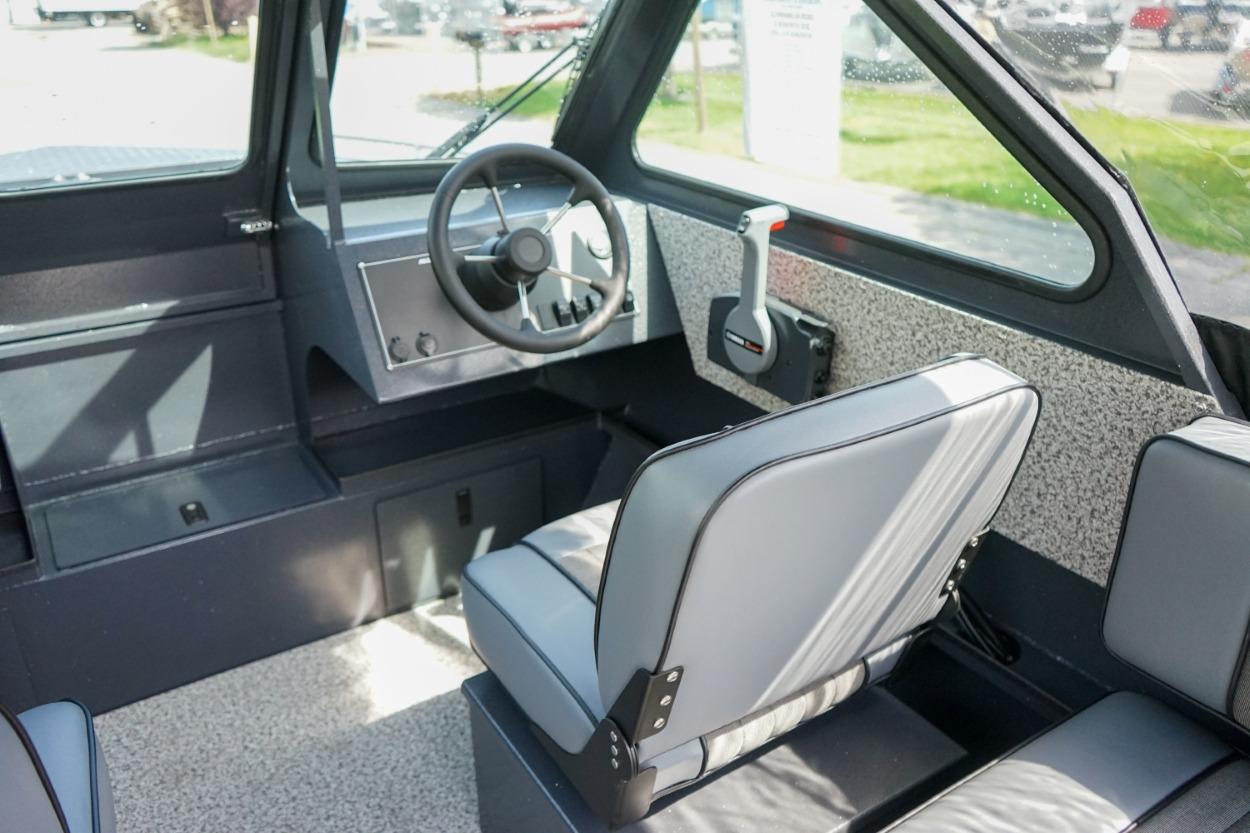 Interior of 2026 Alumaweld X202 Stryker boat, featuring steering wheel and seating.