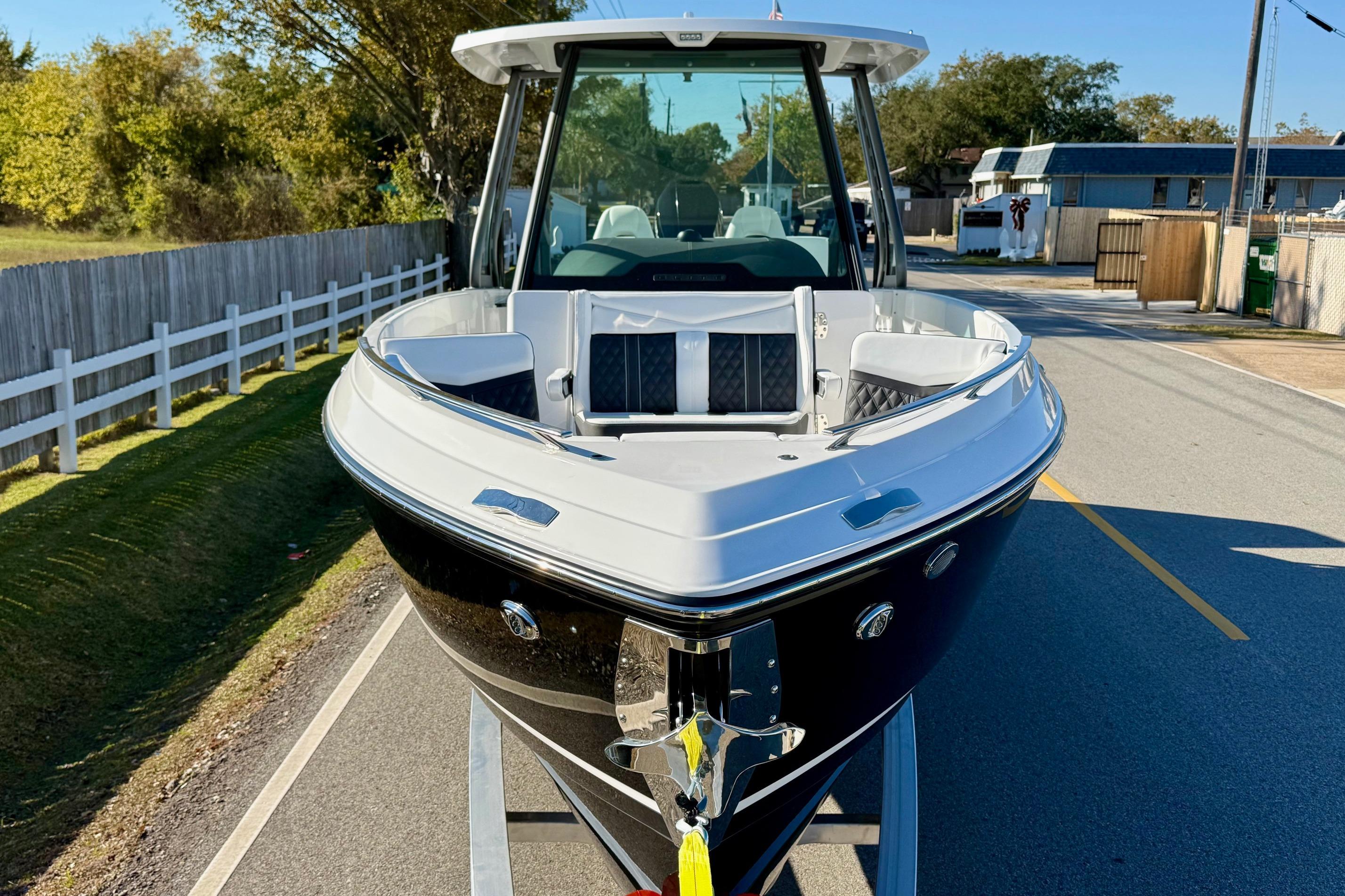 2026 Monterey Elite 27 OB boat on trailer, front view.