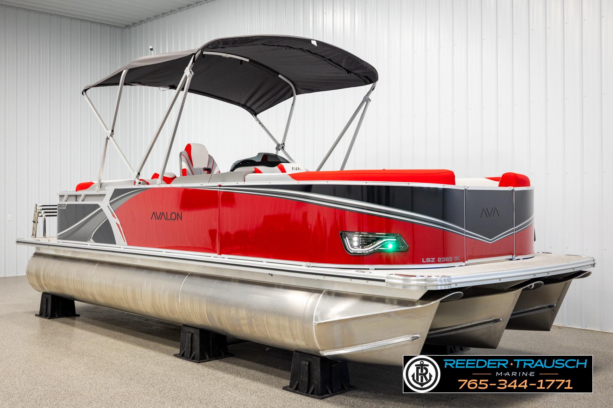 2026 Avalon LSZ QL pontoon boat with red and gray design in showroom.