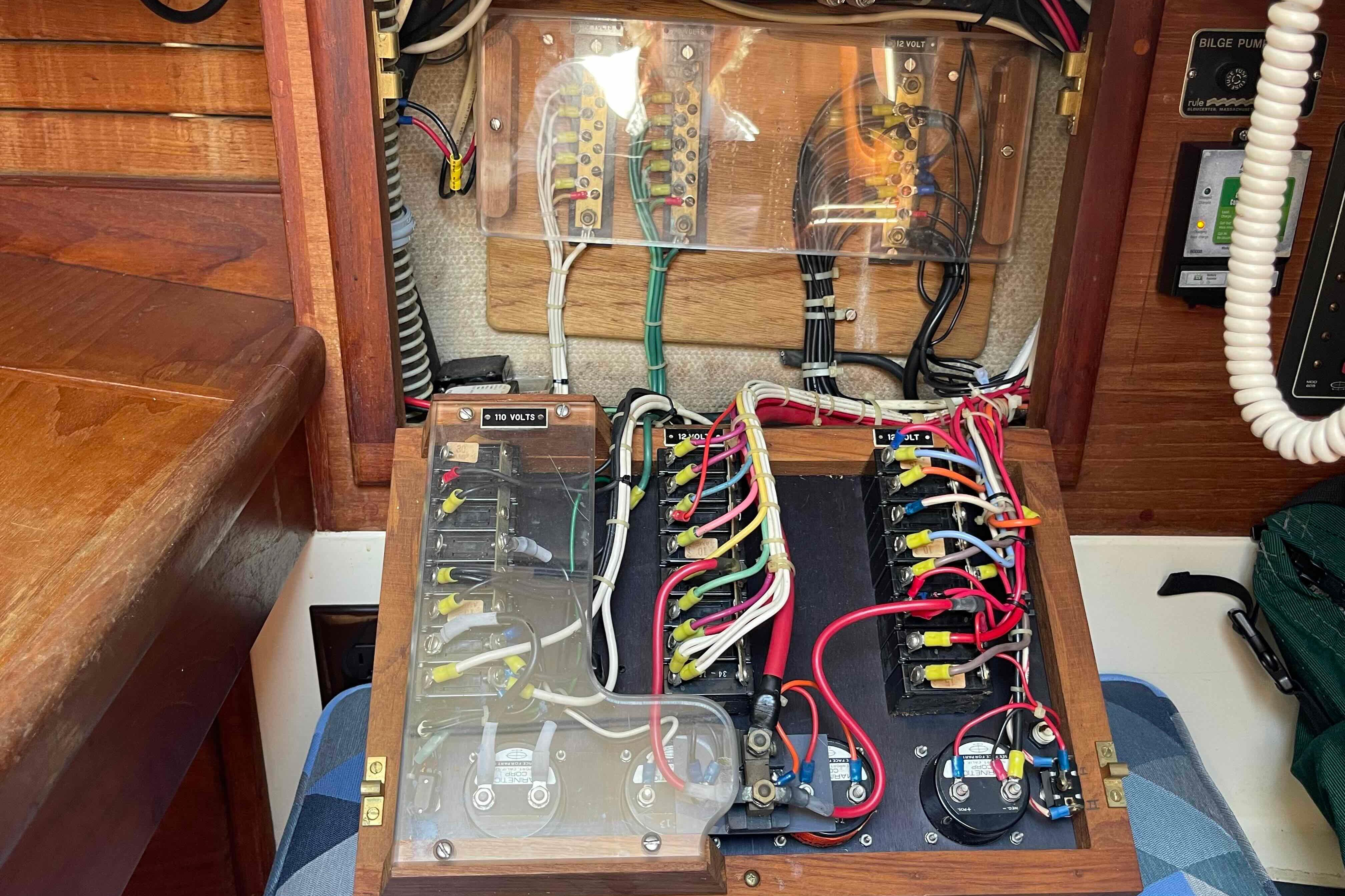 Electrical panel of a 1987 Pacific Seacraft 34 sailboat, showcasing wiring and circuit breakers.