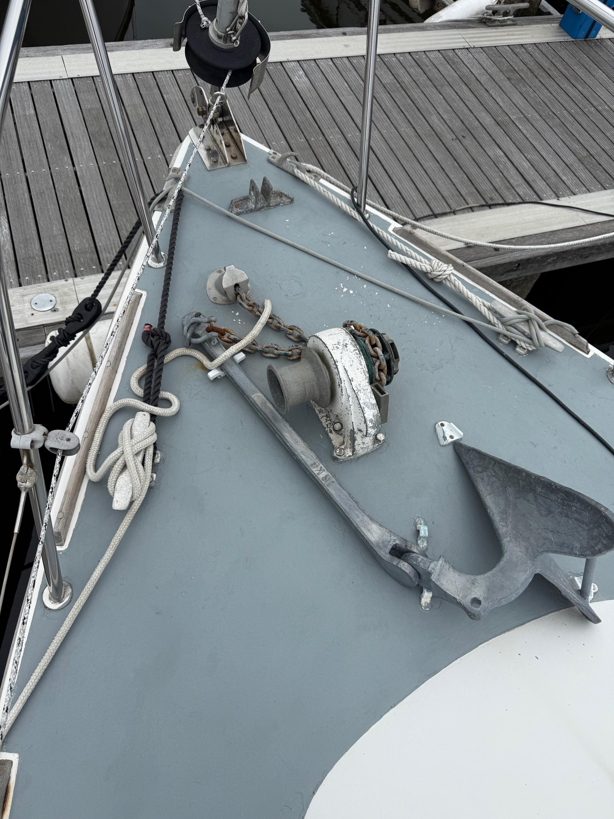 1980 Westerly Konsort sailboat bow with anchor and ropes at dock.