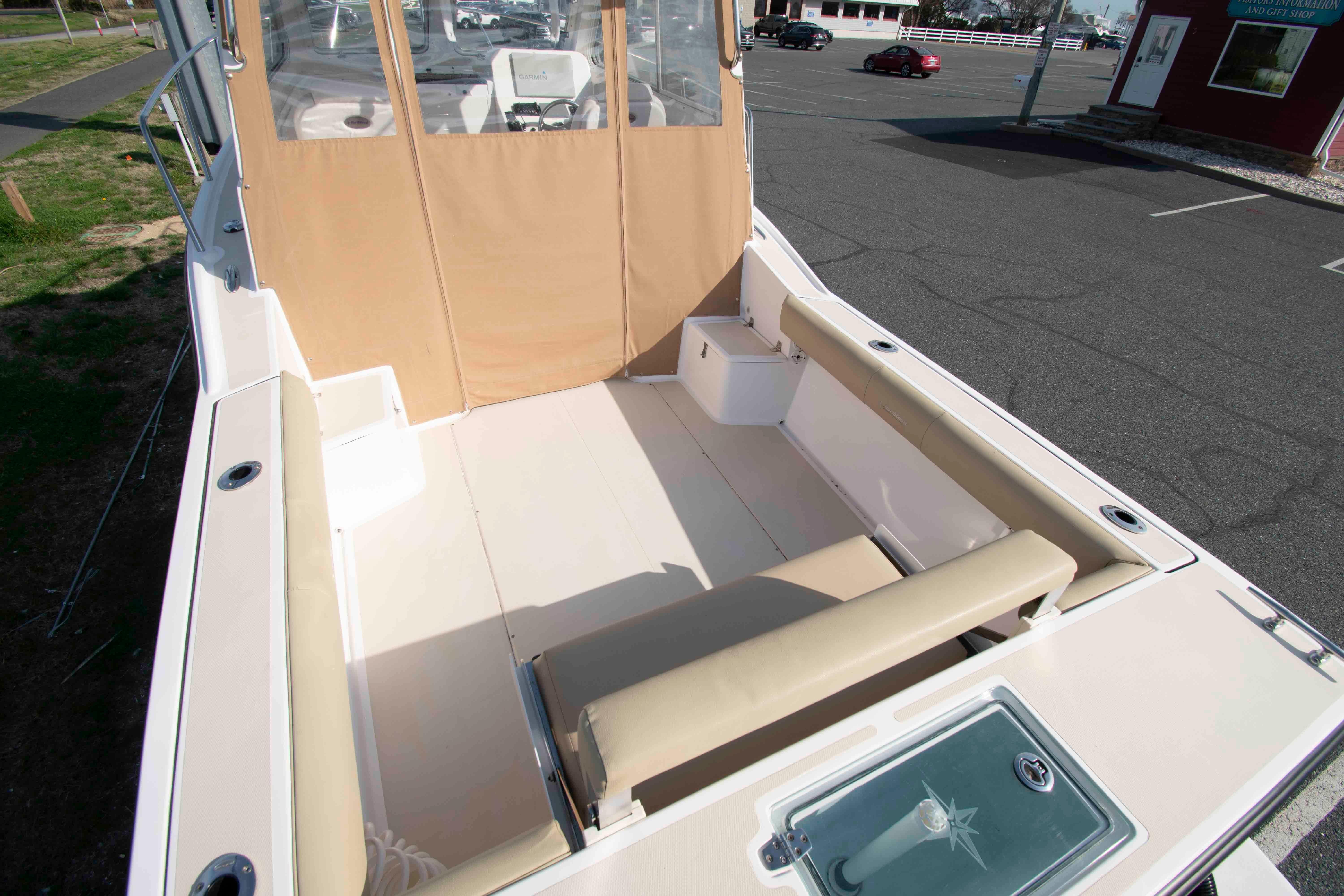 2020 NorthCoast 235 HT boat interior with beige seating and spacious deck area.