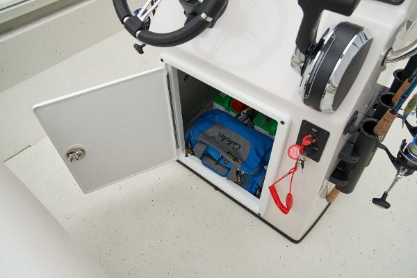 Manufacturer Provided Image: Manufacturer Provided Image: 2025 Ranger RB210 boat storage compartment with open door, showing organized gear and fishing equipment.